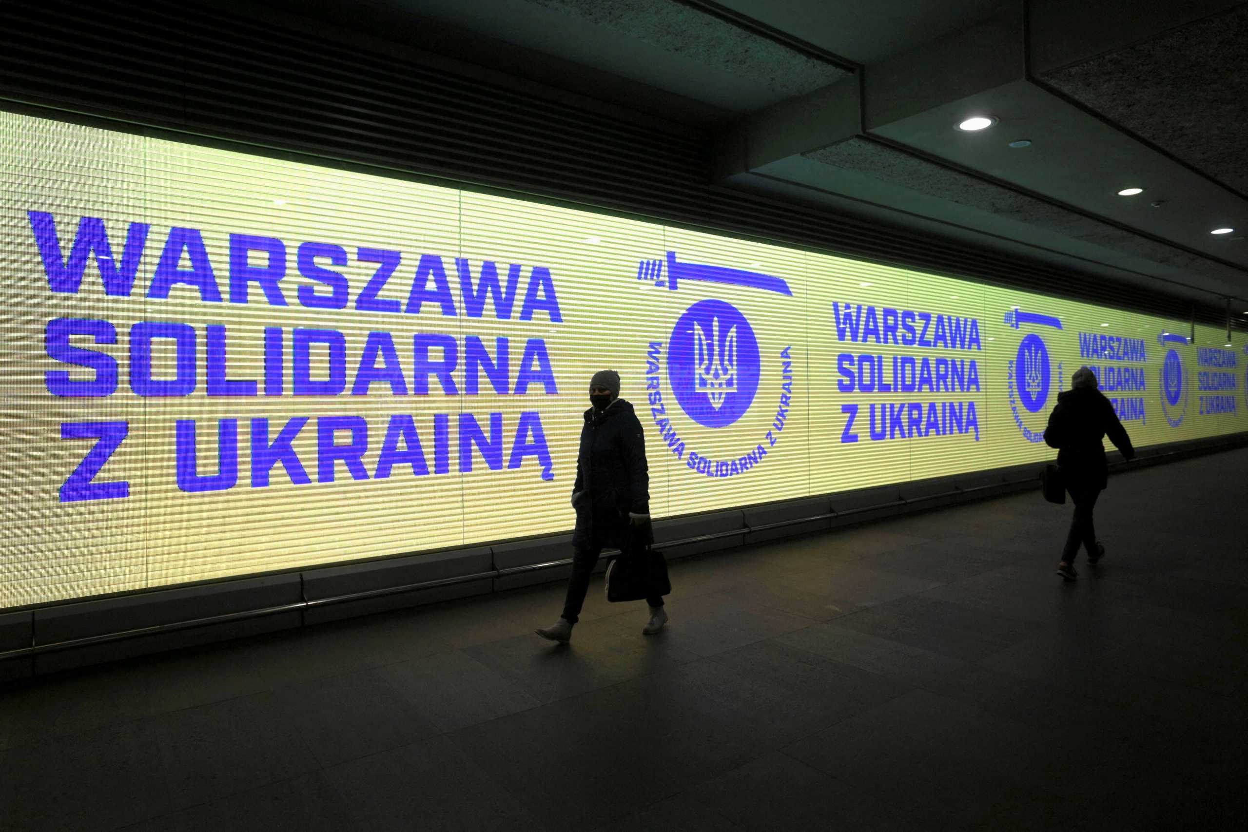 Solidarity messages with Ukraine are displayed on screens at Swietokrzyska metro station in Warsaw, Poland February 24, 2022. Adam Stepien