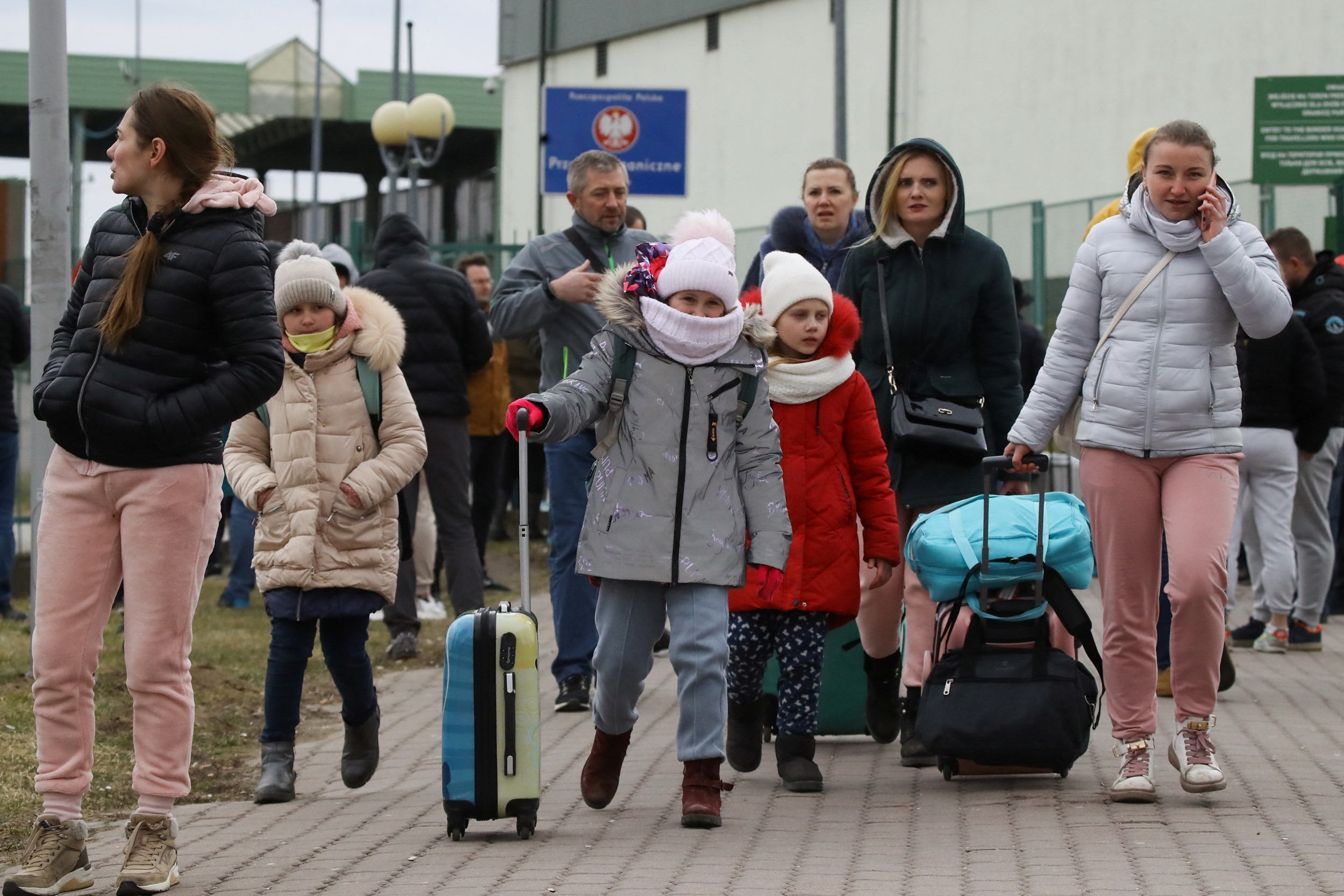 People arrive at the border crossing between Poland and Ukraine, after Russia launched a massive military operation against Ukraine, in Medyka, Poland, February 25, 2022. REUTERS