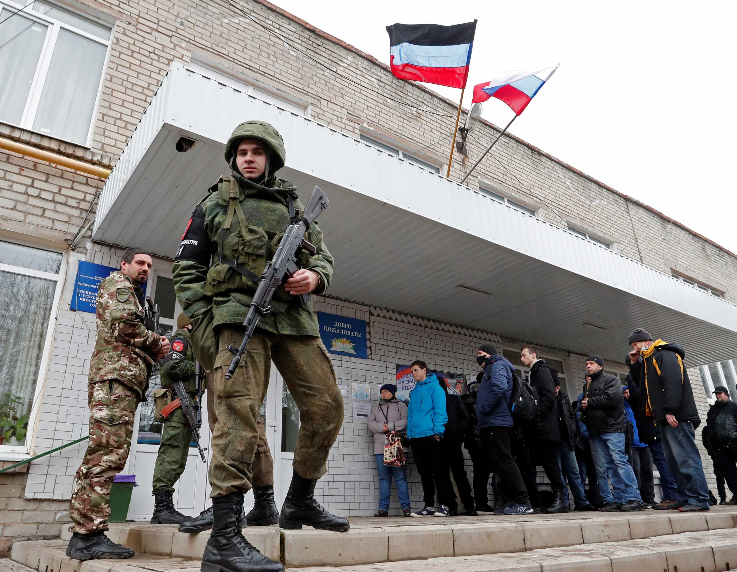 Militants of the self-proclaimed Donetsk People's Republic stand outside a military mobilization point in the separatist-controlled city of Donetsk, Ukraine February 23, 2022. REUTERS