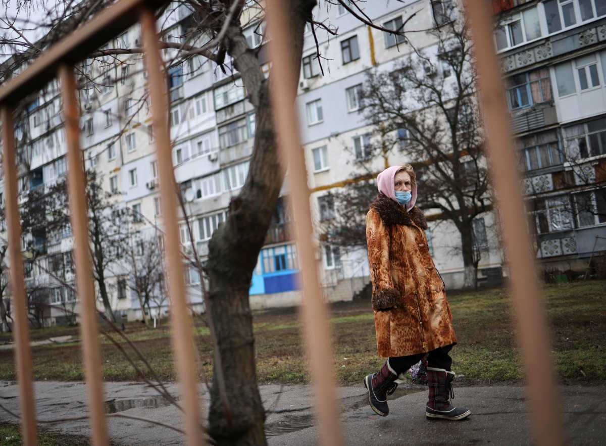 A local resident walks along an empty street, after Russian President Vladimir Putin authorized a military operation in eastern Ukraine, in Berdyans'k, Ukraine, February 24, 2022. REUTERS