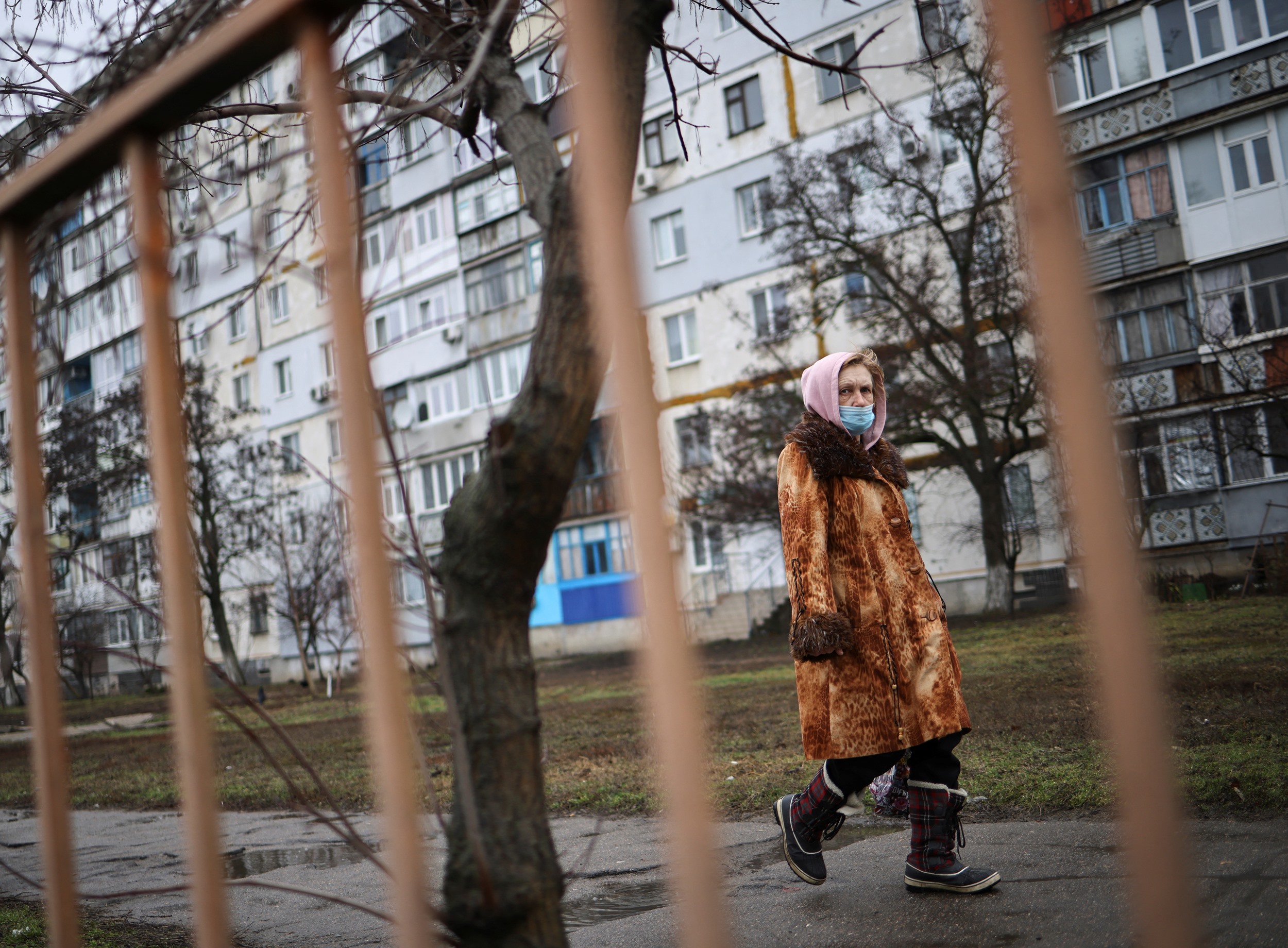 A local resident walks along an empty street, after Russian President Vladimir Putin authorized a military operation in eastern Ukraine, in Berdyans'k, Ukraine, February 24, 2022. REUTERS