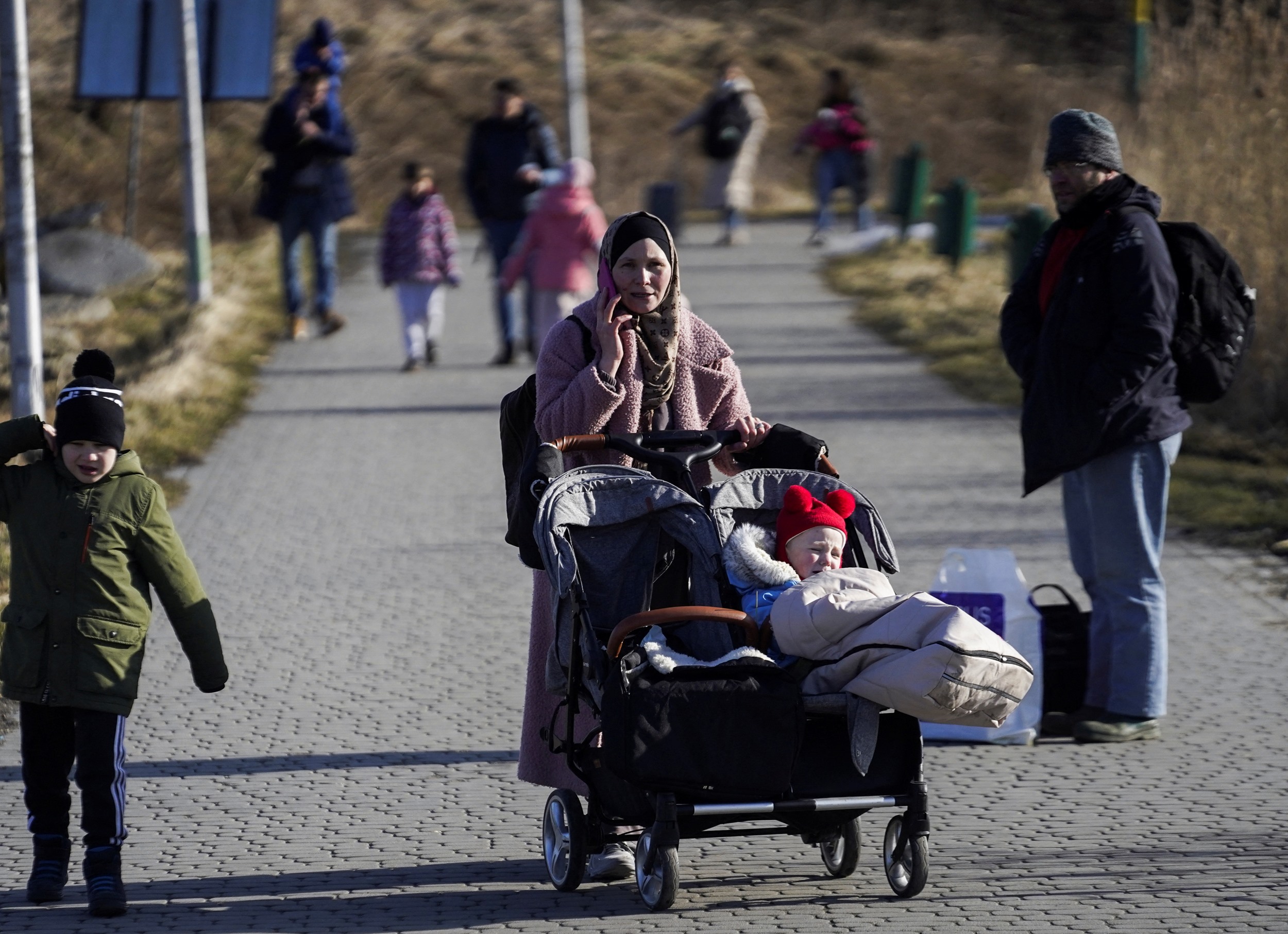 A family arrives at the Polish border crossing after fleeing violence in Ukraine, in Medyka, Poland, February 24, 2022. REUTERS