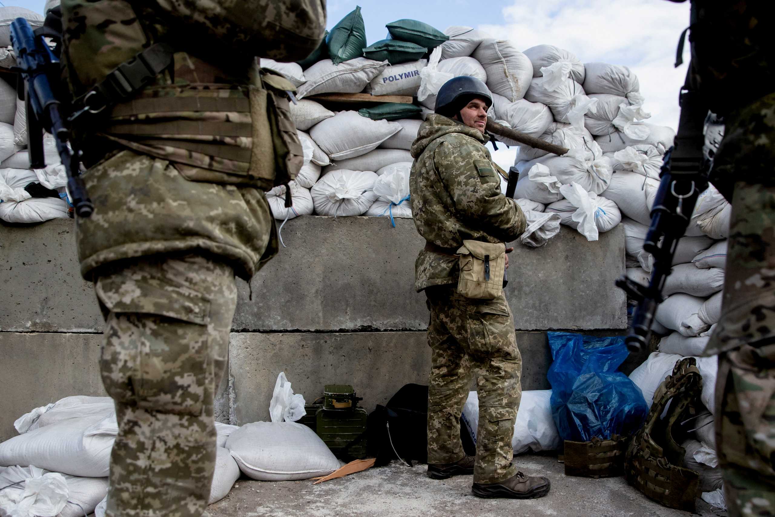 Ukrainian service members are seen after Russia launched a massive military operation against Ukraine, at a check point in the city of Zhytomyr, Ukraine February 27, 2022.  REUTERS