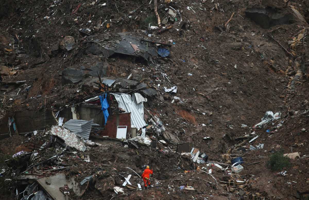 A rescue worker stands at the site of a mudslide at Morro da Oficina, following heavy rainfall in Petropolis, Brazil February 18, 2022. REUTERS