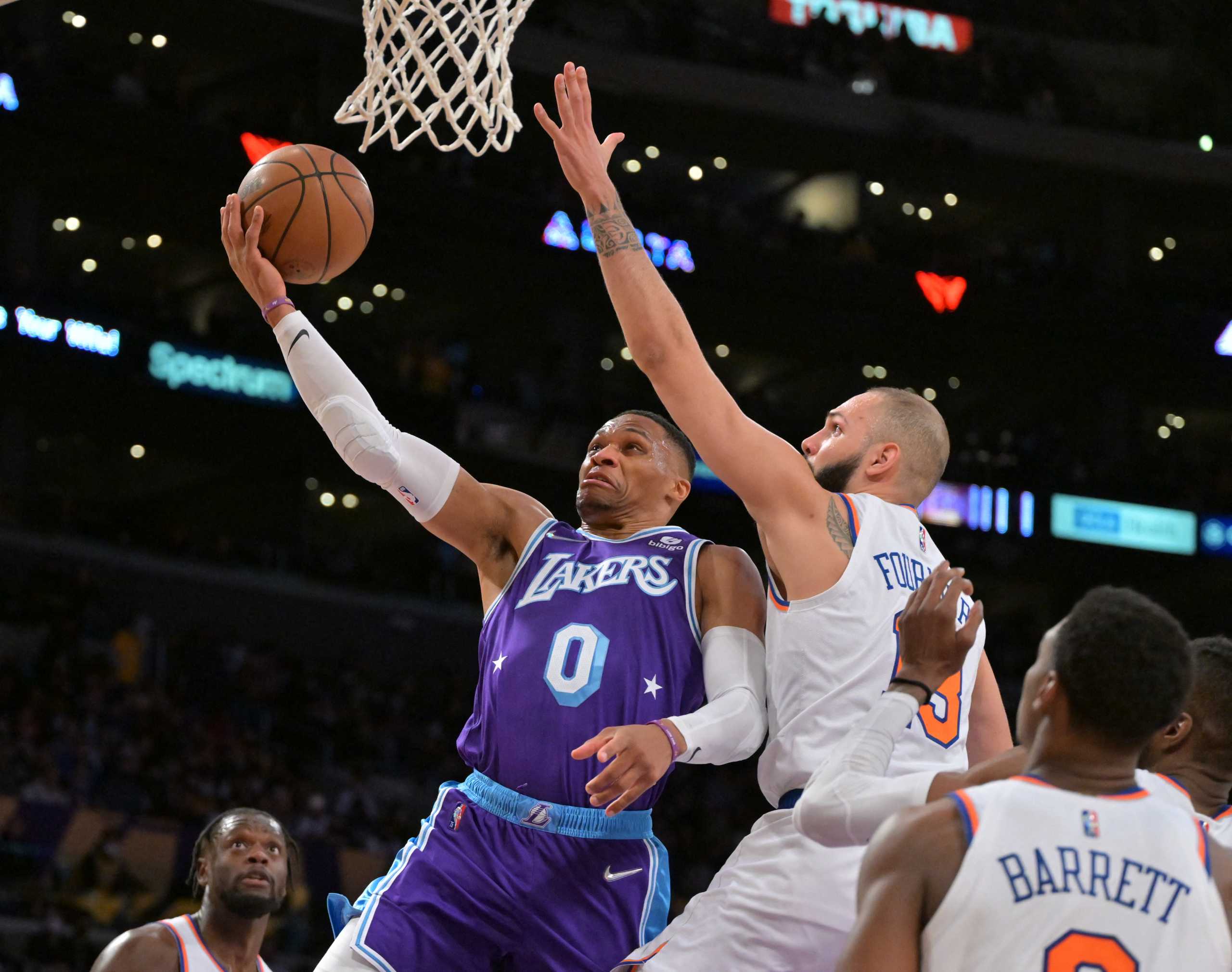 Feb 5, 2022; Los Angeles, California, USA;   Los Angeles Lakers guard Russell Westbrook (0) misses a layup as he is defended by New York Knicks guard Evan Fournier (13) in the second half at Crypto.com Arena. Mandatory Credit: Jayne Kamin-Oncea-USA TODAY Sports