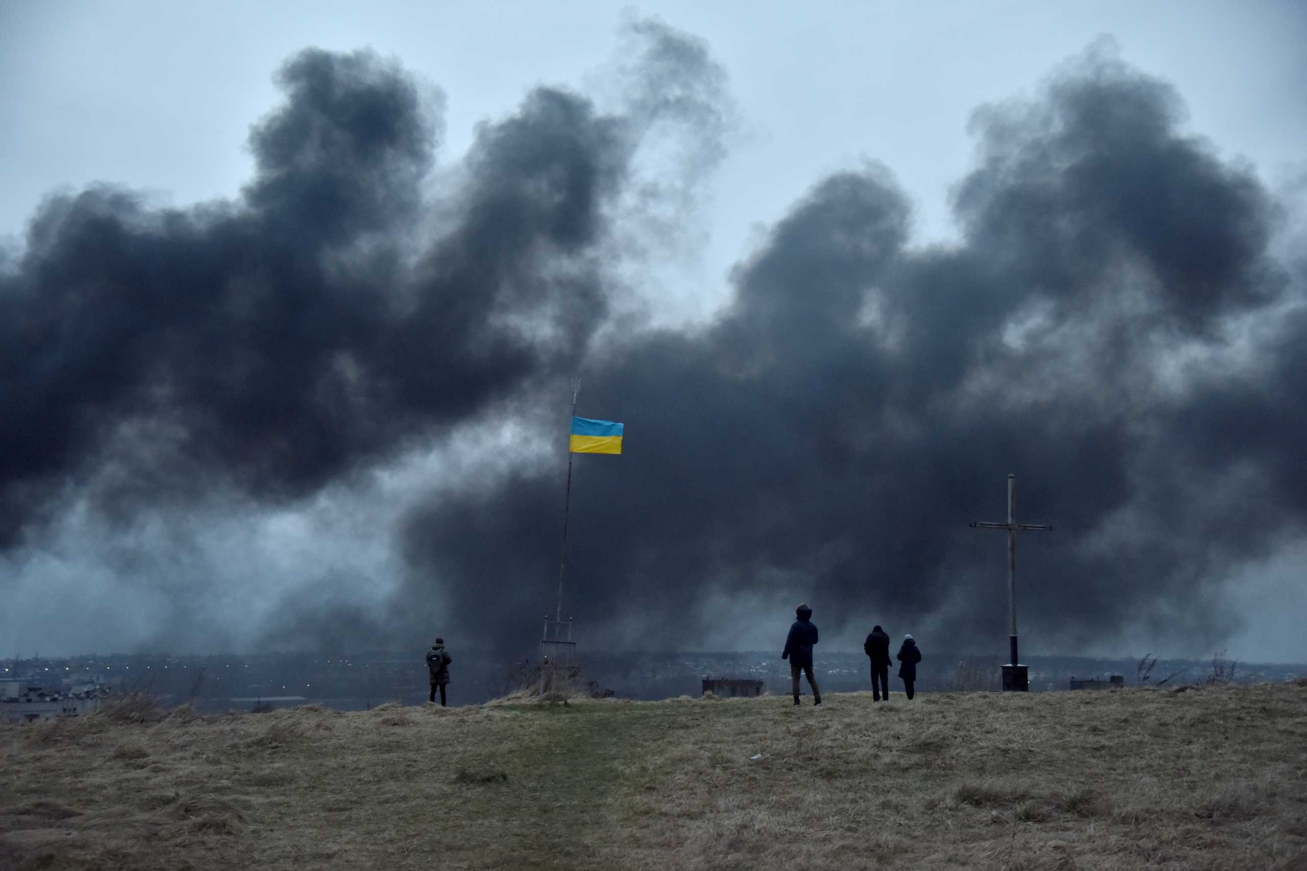 People watch as smoke rises after an airstrike, as Russia's attack on Ukraine continues, in Lviv, Ukraine March 26, 2022. REUTERS