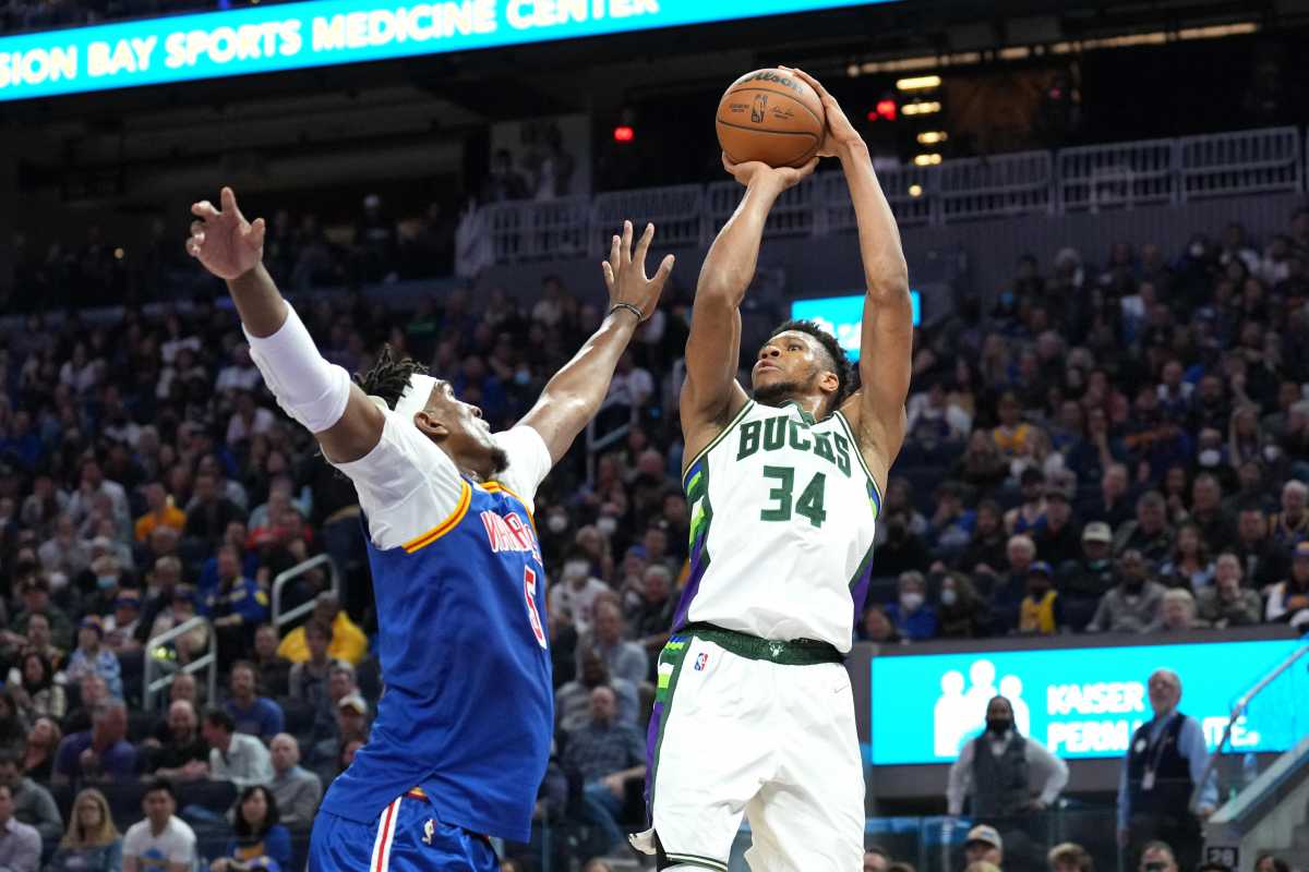 Mar 12, 2022; San Francisco, California, USA; Milwaukee Bucks forward Giannis Antetokounmpo (34) shoots against Golden State Warriors center Kevon Looney (5) during the second quarter at Chase Center. Mandatory Credit: Darren Yamashita-USA TODAY Sports