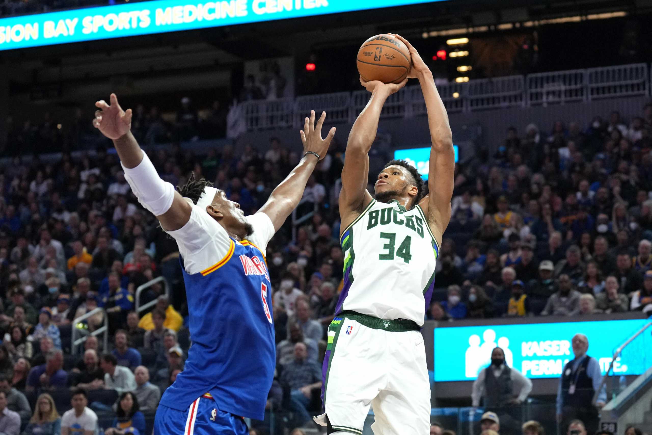 Mar 12, 2022; San Francisco, California, USA; Milwaukee Bucks forward Giannis Antetokounmpo (34) shoots against Golden State Warriors center Kevon Looney (5) during the second quarter at Chase Center. Mandatory Credit: Darren Yamashita-USA TODAY Sports