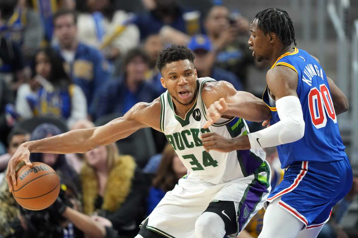 Mar 12, 2022; San Francisco, California, USA; Milwaukee Bucks forward Giannis Antetokounmpo (34) dribbles against Golden State Warriors forward Jonathan Kuminga (00) during the third quarter at Chase Center. Mandatory Credit: Darren Yamashita-USA TODAY Sports