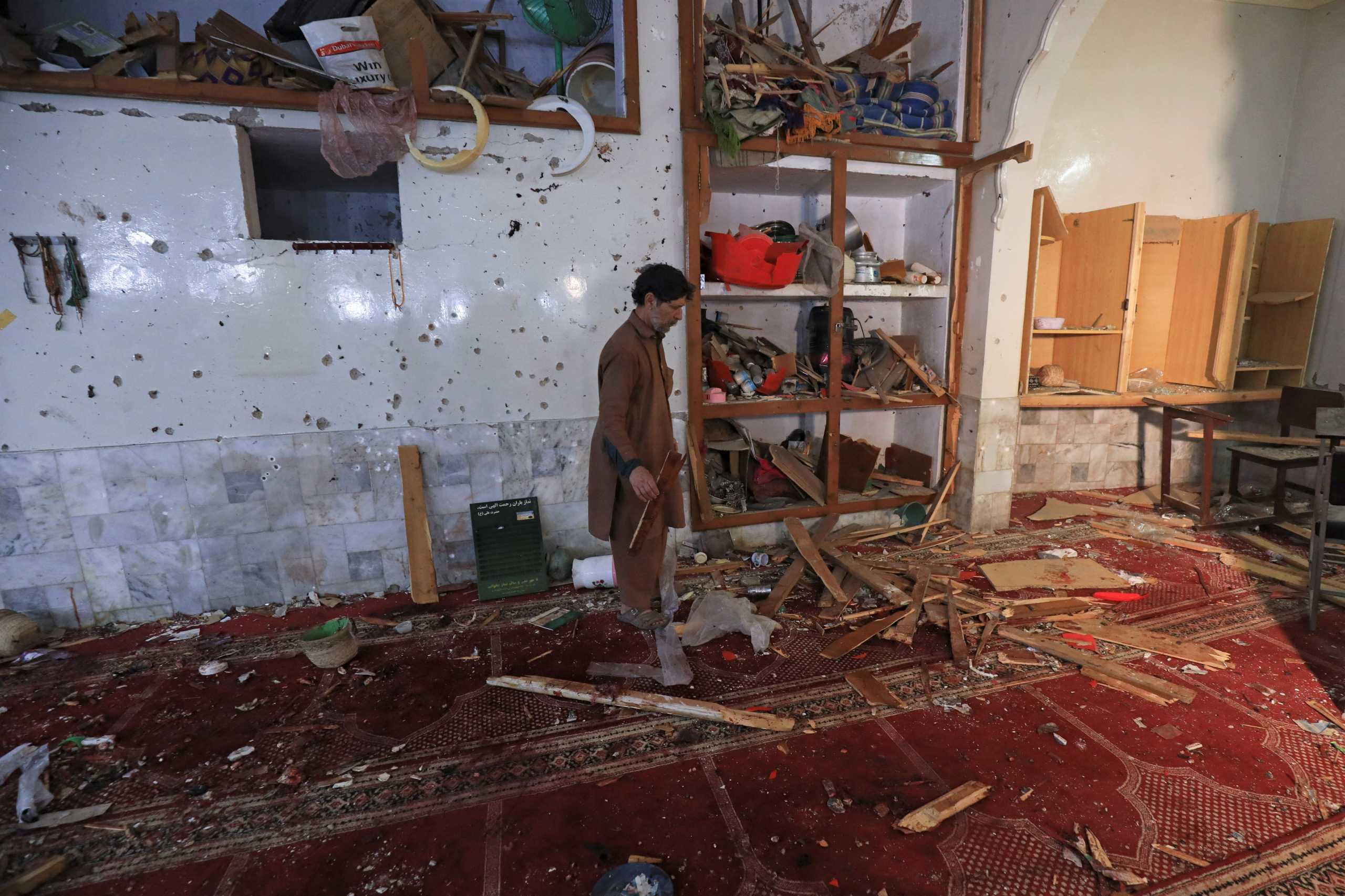 A man walks amid the damages at the prayer hall after a bomb blast inside a mosque during Friday prayers in Peshawar, Pakistan, March 4, 2022. REUTERS