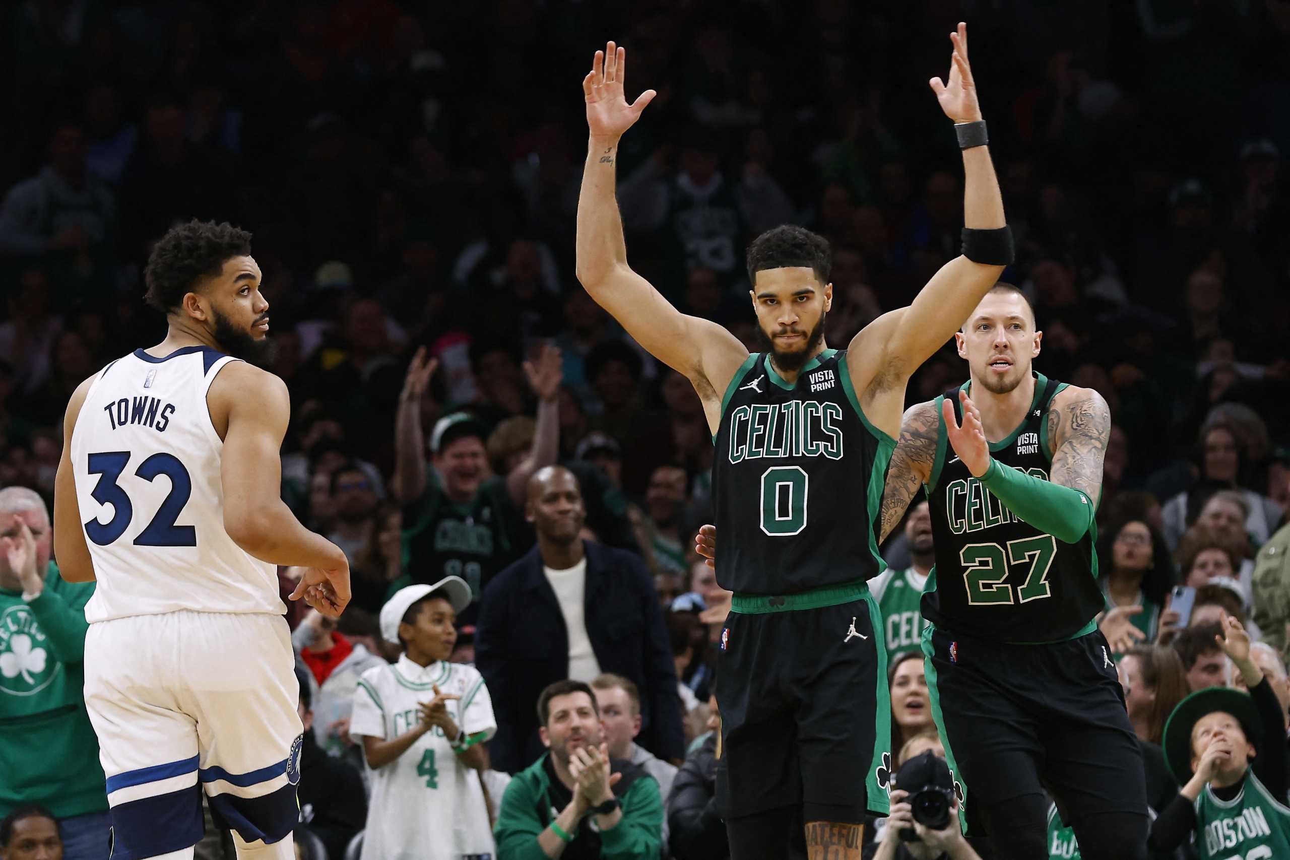 Mar 27, 2022; Boston, Massachusetts, USA; Boston Celtics forward Jayson Tatum (0) celebrates a dunk with center Daniel Theis (27) as Minnesota Timberwolves center Karl-Anthony Towns (32) looks on during the second half at TD Garden. Mandatory Credit: Winslow Townson-USA TODAY Sports