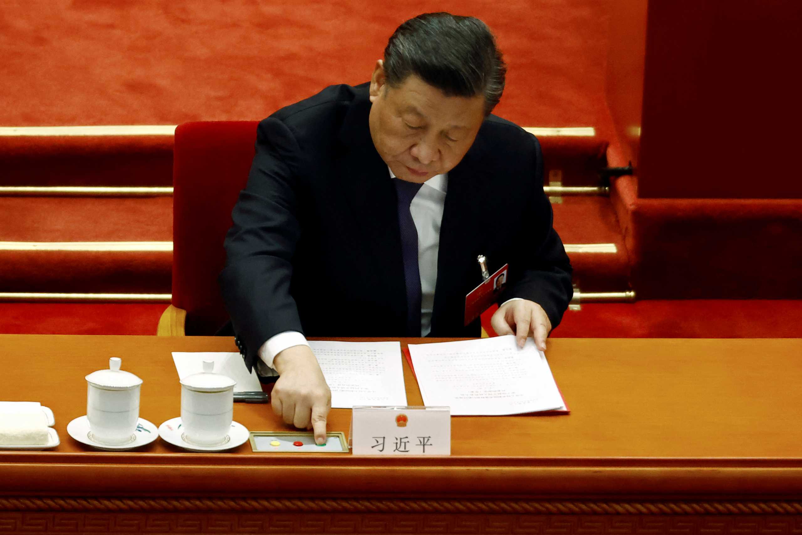 Chinese President Xi Jinping casts a vote during the closing session of the National People's Congress (NPC) at the Great Hall of the People in Beijing, China March 11, 2022. REUTERS