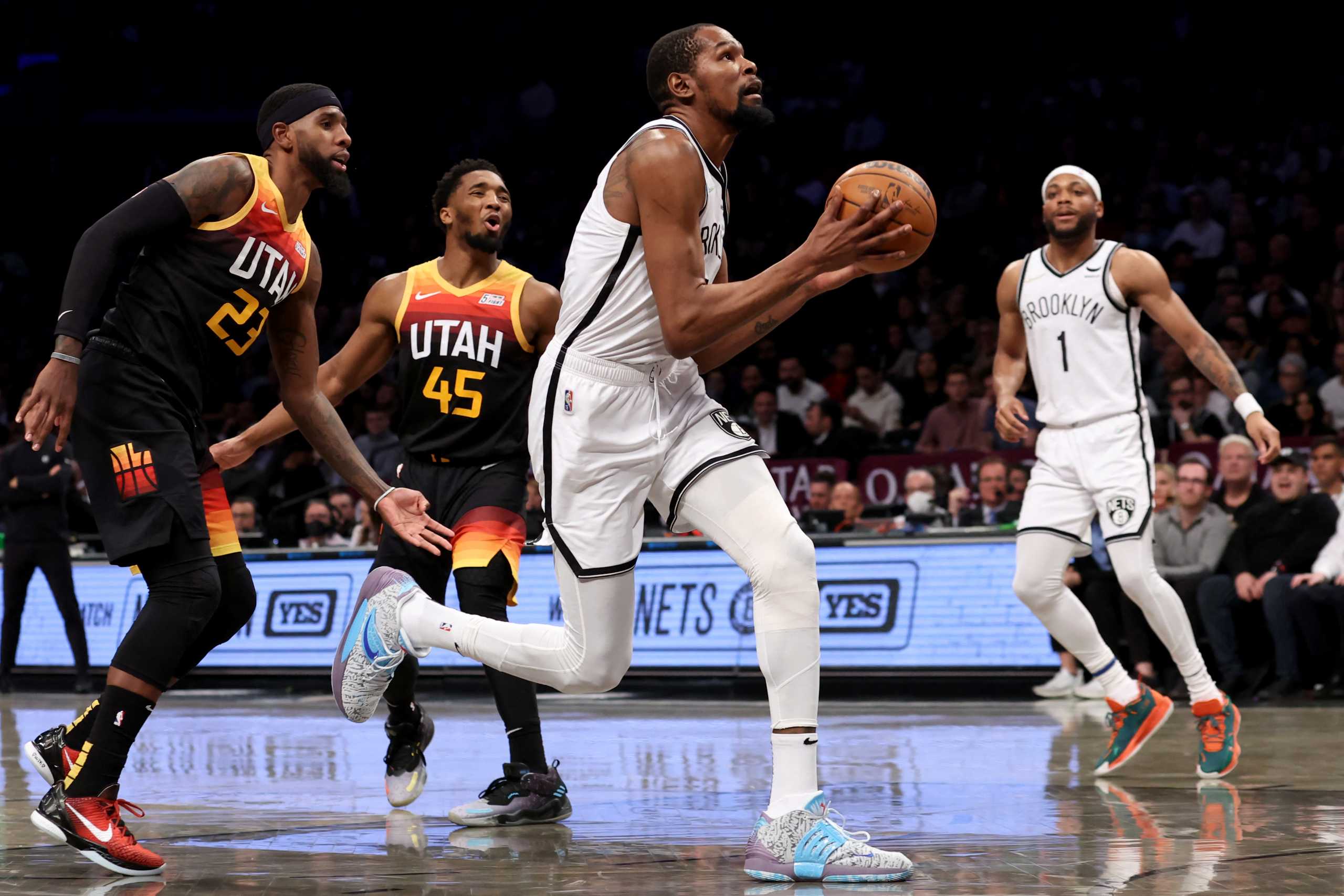 Mar 21, 2022; Brooklyn, New York, USA; Brooklyn Nets forward Kevin Durant (7) drives to the basket against Utah Jazz forward Royce O'Neale (23) and Utah Jazz guard Donovan Mitchell (45) during the second quarter at Barclays Center. Mandatory Credit: Brad Penner-USA TODAY Sports