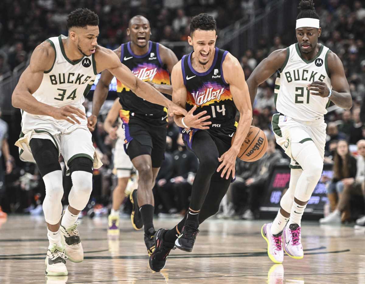 Mar 6, 2022; Milwaukee, Wisconsin, USA; Milwaukee Bucks forward Giannis Antetokounmpo (34) tries to steal the ball from Phoenix Suns guard Landry Shamet (14) in the second quarter at Fiserv Forum. Mandatory Credit: Benny Sieu-USA TODAY Sports
