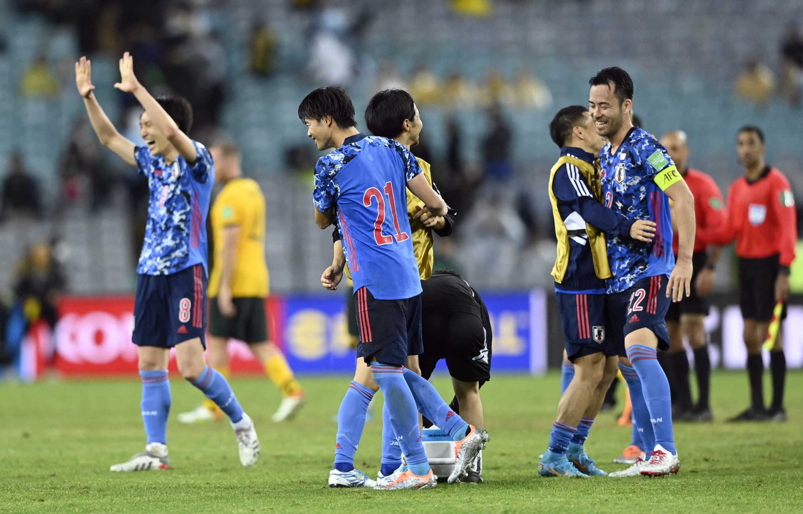 Soccer Football - World Cup - Asian Qualifiers - Group B - Australia v Japan - Stadium Australia, Sydney, Australia - March 24, 2022 Genki Haraguchi, Kaoru Mitoma and Maya Yoshida celebrate after the match REUTERS
