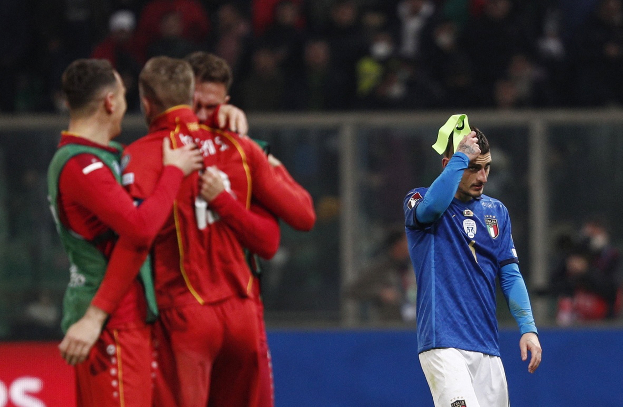 Soccer Football - World Cup - UEFA Qualifiers - Play-Off Semi Final - Italy v North Macedonia - Stadio Renzo Barbera, Palermo, Italy - March 24, 2022 Italy's Marco Verratti looks dejected as North Macedonia players celebrate after the match REUTERS