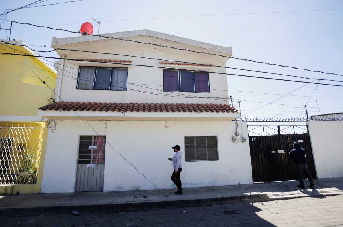 A person walks past the house where nine people were killed by unknown assailants, according to local media, in Atlixco, Mexico March 9, 2022. REUTERS