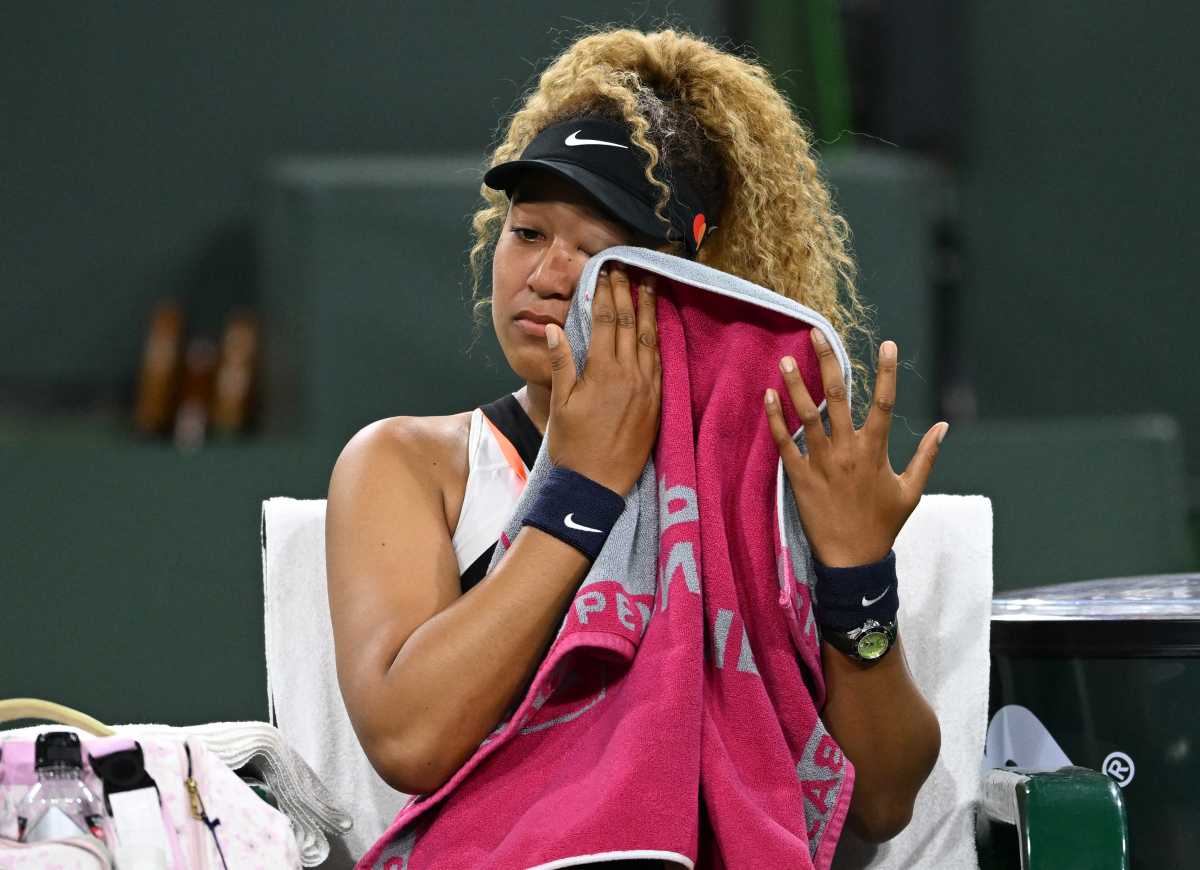 Mar 12, 2022; Indian Wells, CA, USA; Naomi Osaka (JPN) wipes her face as she talks to referee Claire Wood after a spectator disrupted play, yelling Naomi you suck, before the start of her 2nd round match against Veronika Kudermetova (RUS) at the BNP Paribas open at the Indian Wells Tennis Garden. Mandatory Credit: Jayne Kamin-Oncea-USA TODAY Sports