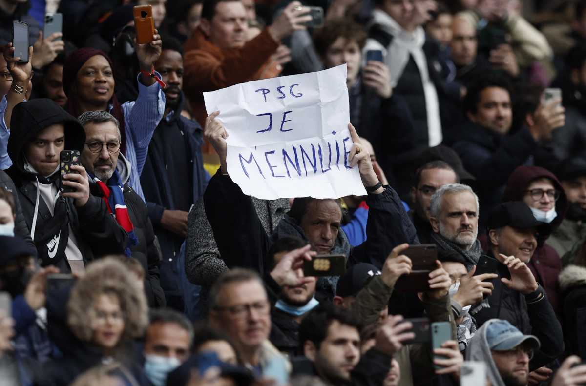 Soccer Football - Ligue 1 - Paris St Germain v Bordeaux - Parc des Princes, Paris, France - March 13, 2022 Paris St Germain fan holds a sign aloft that reads "PSG je m'ennuie" inside the stadium before the match REUTERS