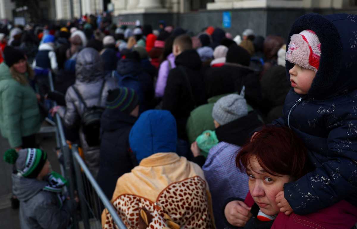 Refugees fleeing the ongoing Russian invasion of Ukraine wait for hours to board a train to Poland, outside the train station in Lviv, Ukraine, March 8, 2022. REUTERS