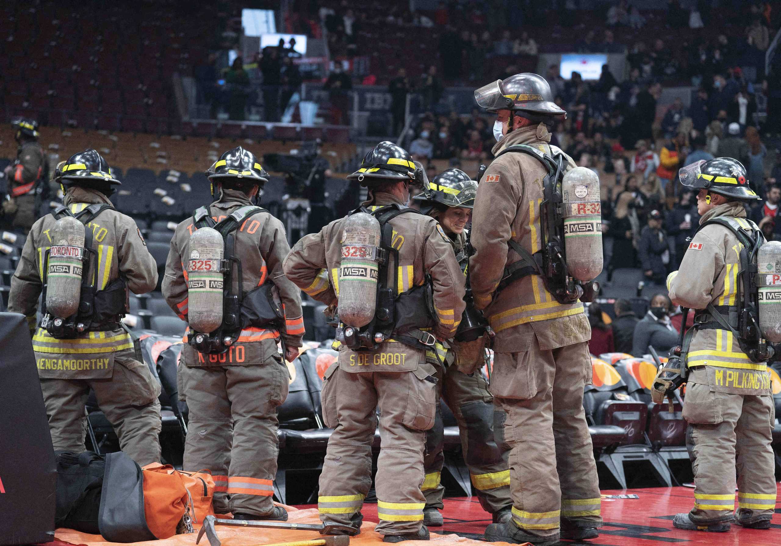 Mar 26, 2022; Toronto, Ontario, CAN; The Toronto Fire Department watches as fans begin to exit Scotiabank Arena due to a fire emergency during the second quarter between the Indiana Pacers and Toronto Raptors. Mandatory Credit: Nick Turchiaro-USA TODAY Sports