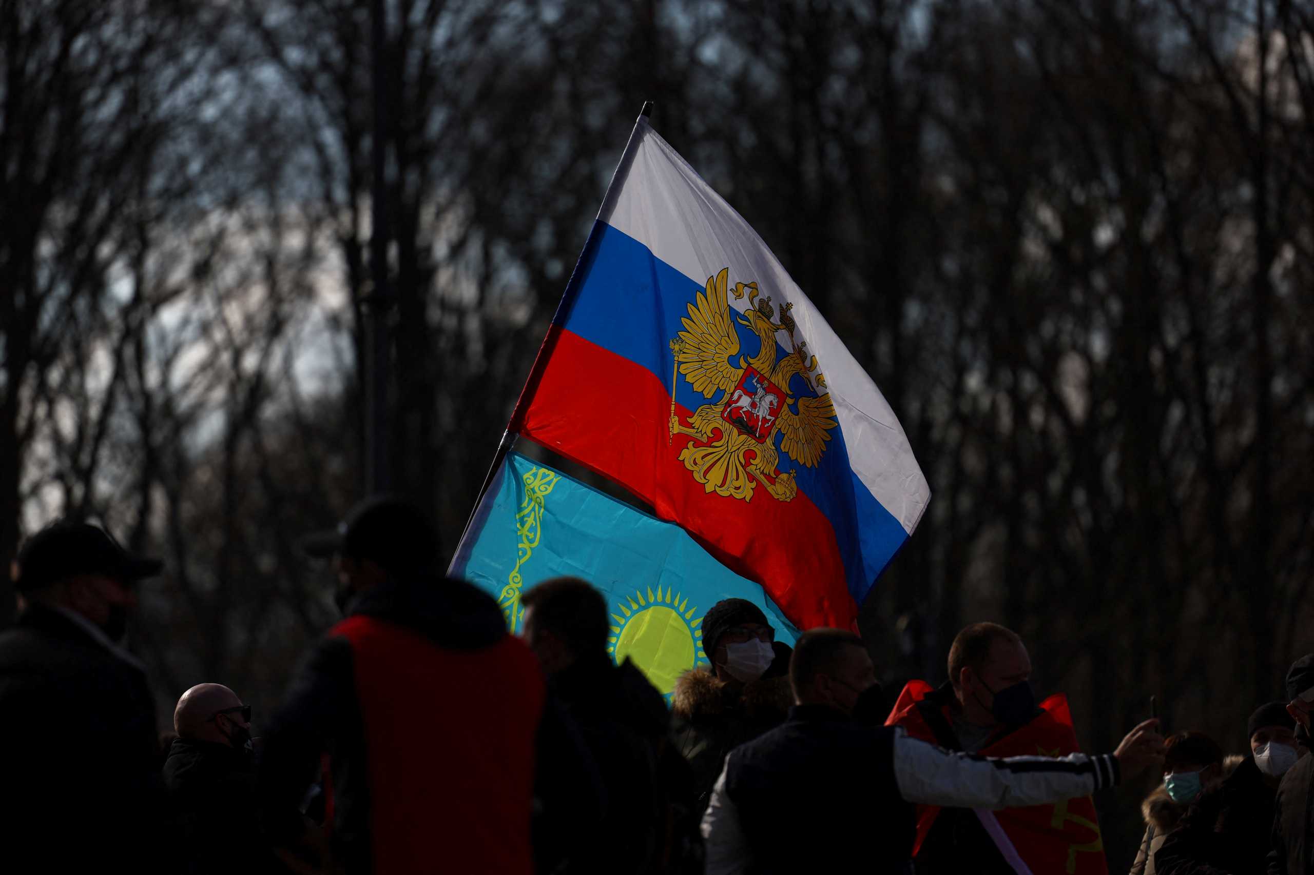 People carrying a Russian flag protest after Russia's invasion of Ukraine, in Berlin, Germany, March 5, 2022. REUTERS