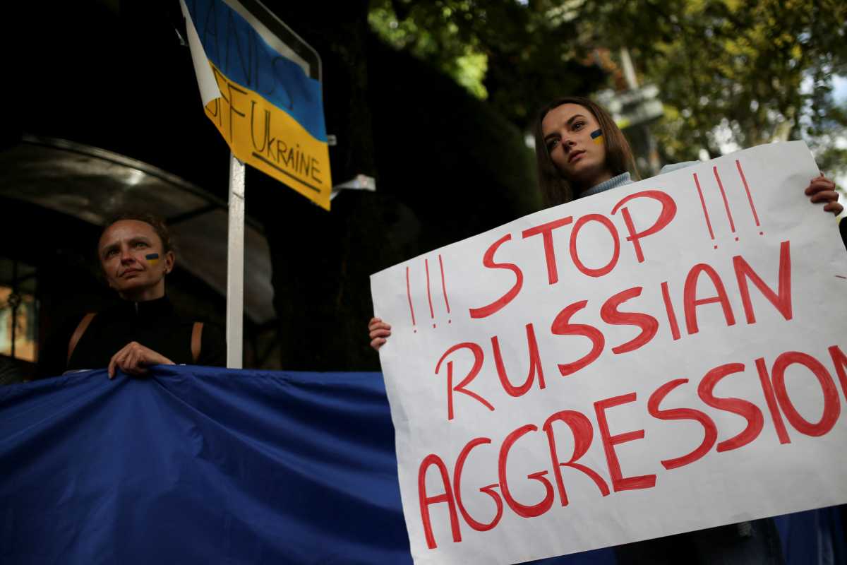 A woman holds a sign as she attends an anti-war protest outside the Russian Embassy, following Russia's invasion of Ukraine, in Bogota, Colombia March 1, 2022. REUTERS