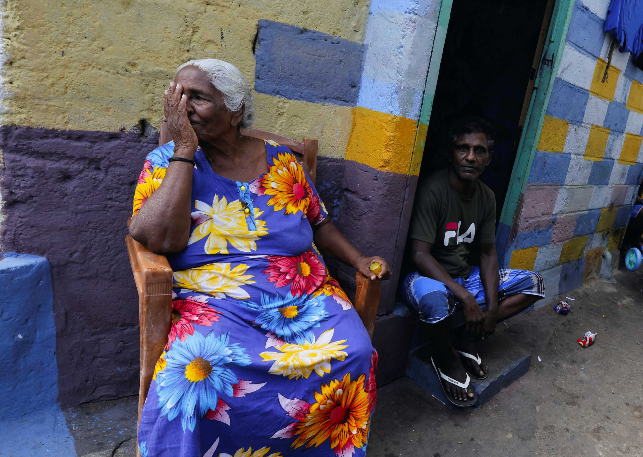 People sit outside to cool themselves from heat during the power cut as many parts of the country currently face long power cuts, as currency shortage makes fuel scarce, in Colombo, Sri Lanka  March 31, 2022. REUTERS