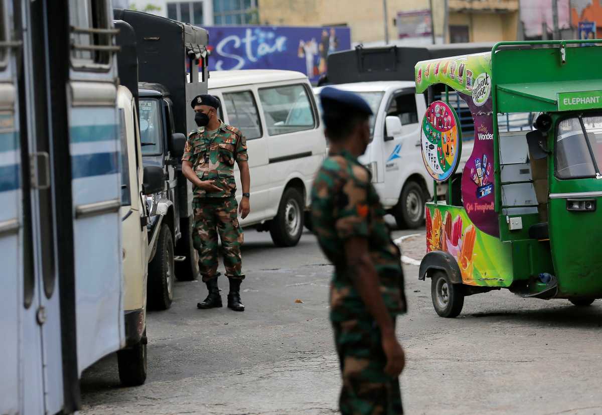 Sri Lanka's Army members stand guard at a Ceylon Petroleum Corporation fuel station to help stations distribute oil during the fuel crisis, in Colombo, Sri Lanka March 22, 2022. REUTERS