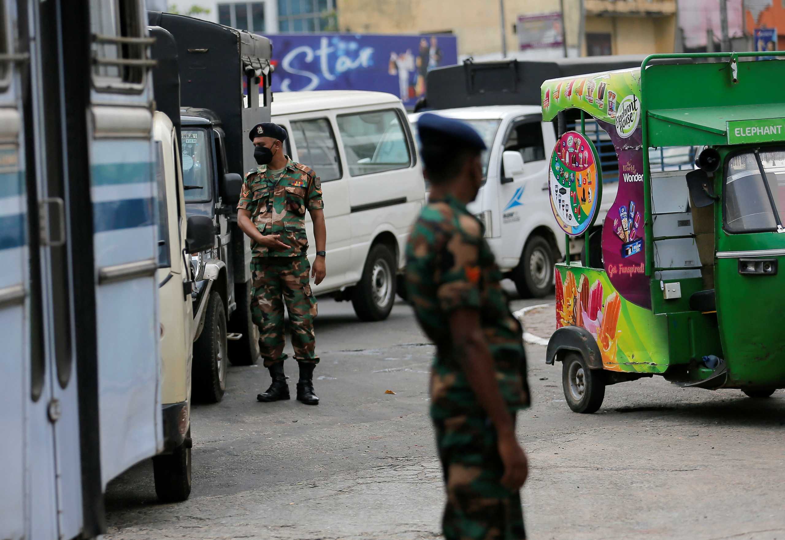 Sri Lanka's Army members stand guard at a Ceylon Petroleum Corporation fuel station to help stations distribute oil during the fuel crisis, in Colombo, Sri Lanka March 22, 2022. REUTERS