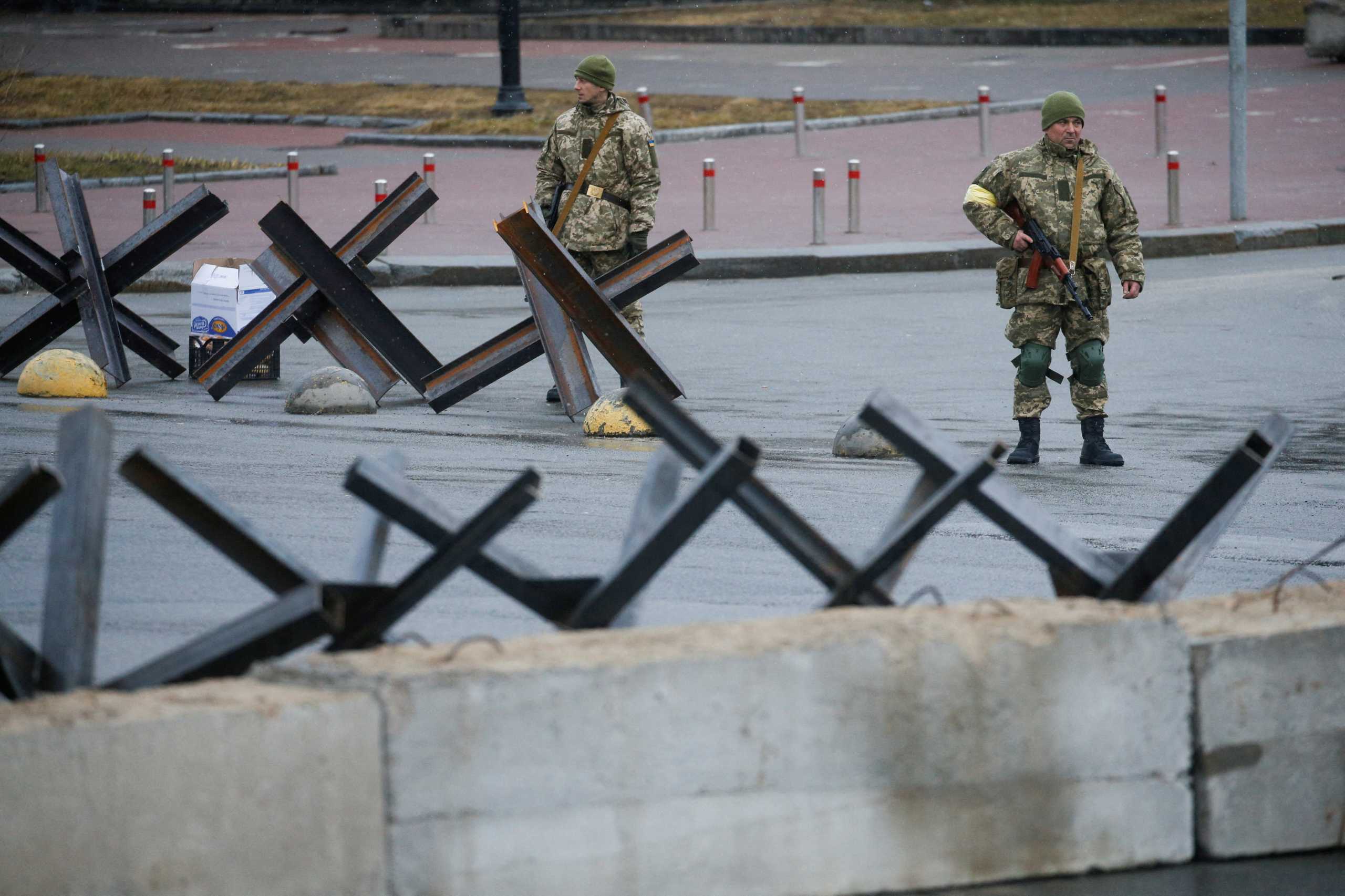 FILE PHOTO: Members of the Territorial Defence Force stand guard at a check point, as Russia's invasion of Ukraine continues, at the Independence Square in central Kyiv, Ukraine, March 3, 2022. REUTERS