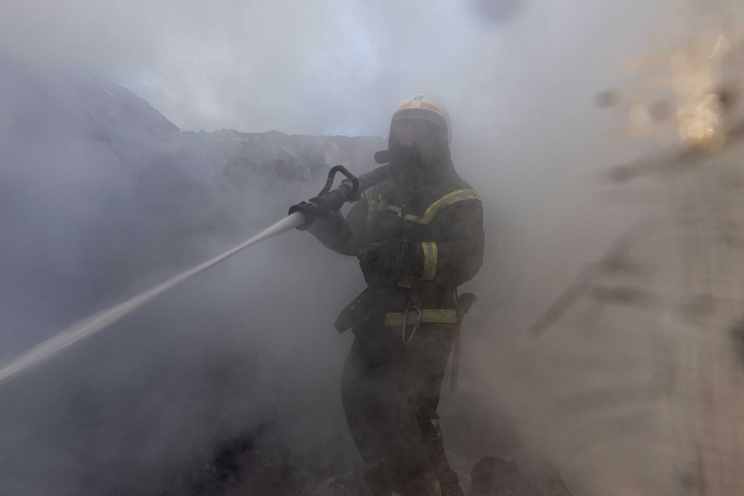 A firefighter works at a residential district that was damaged by shelling, as Russia's invasion of Ukraine continues, in Kyiv, Ukraine March 23, 2022. REUTERS
