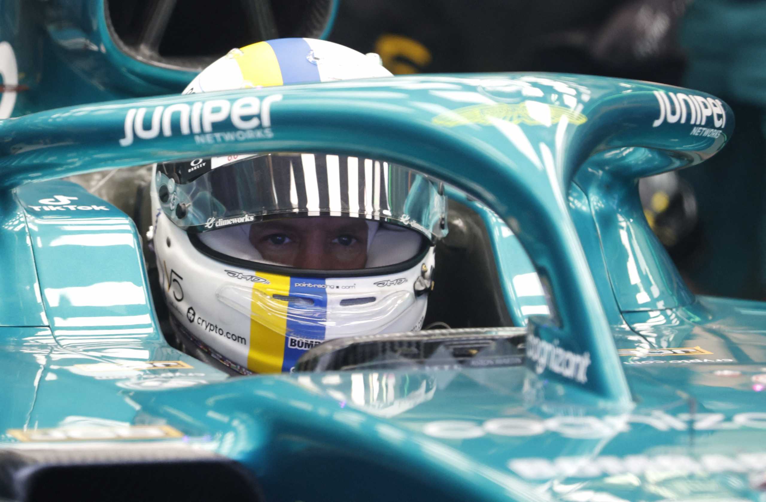 Formula One F1 - Pre-Season Testing - Bahrain International Circuit, Sakhir, Bahrain - March 11, 2022 Aston Martin's Sebastian Vettel with the Ukraine national colours on his helmet during testing REUTERS