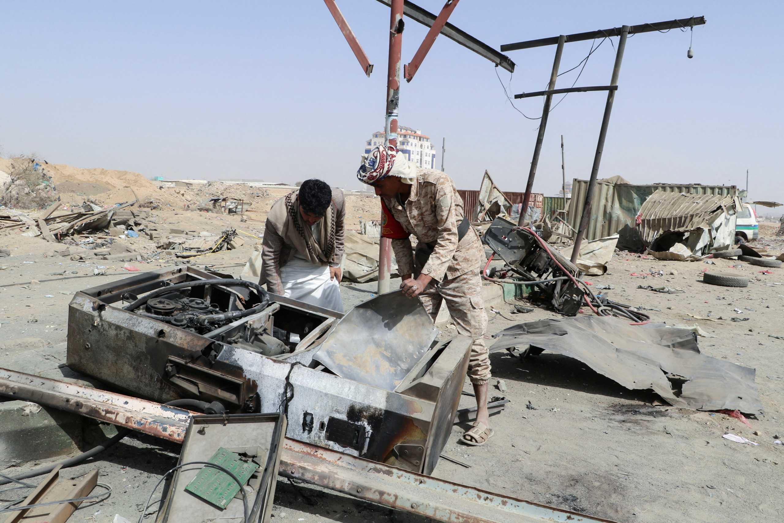 A man and a soldier inspect damage at a gas station hit by a Saudi-led air strike in Saada, Yemen March 26, 2022. REUTERS