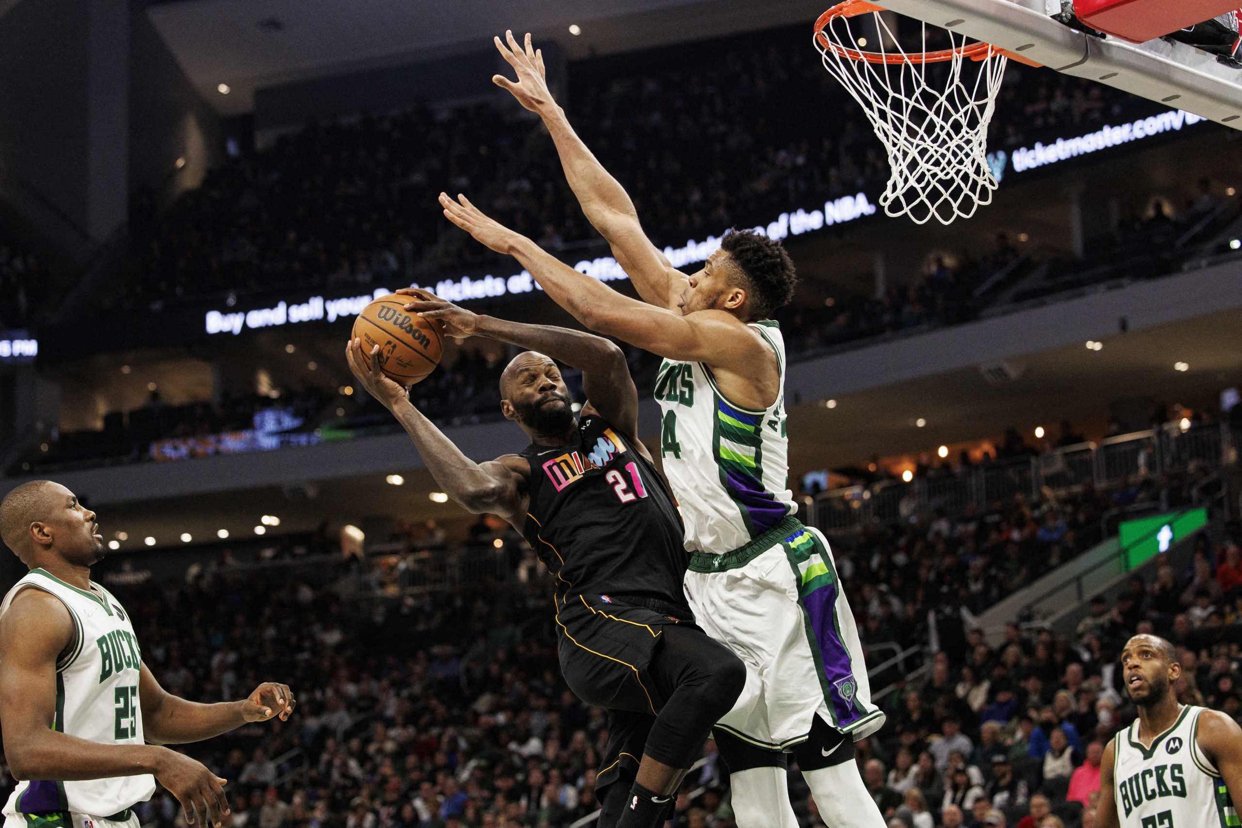 Mar 2, 2022; Milwaukee, Wisconsin, USA;  Miami Heat center Dewayne Dedmon (21) shoots against Milwaukee Bucks forward Giannis Antetokounmpo (34) during the third quarter at Fiserv Forum. Mandatory Credit: Jeff Hanisch-USA TODAY Sports
