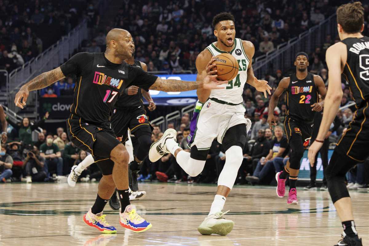 Mar 2, 2022; Milwaukee, Wisconsin, USA;  Miami Heat forward P.J. Tucker (17) hits the ball away from Milwaukee Bucks forward Giannis Antetokounmpo (34) during the first quarter at Fiserv Forum. Mandatory Credit: Jeff Hanisch-USA TODAY Sports