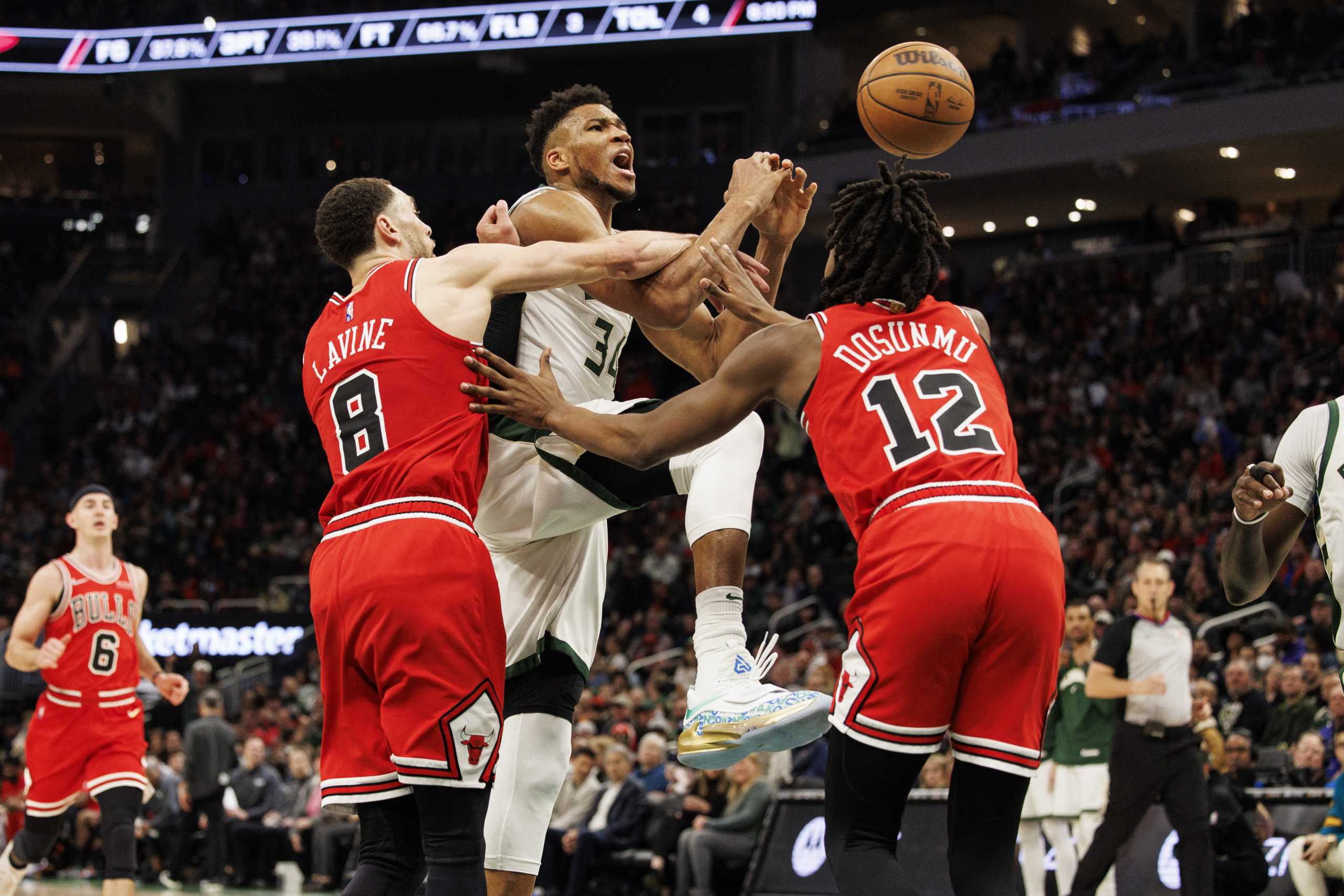 Mar 22, 2022; Milwaukee, Wisconsin, USA;  Milwaukee Bucks forward Giannis Antetokounmpo (34) is fouled by Chicago Bulls guard Zach LaVine (8) during the third quarter at Fiserv Forum. Mandatory Credit: Jeff Hanisch-USA TODAY Sports