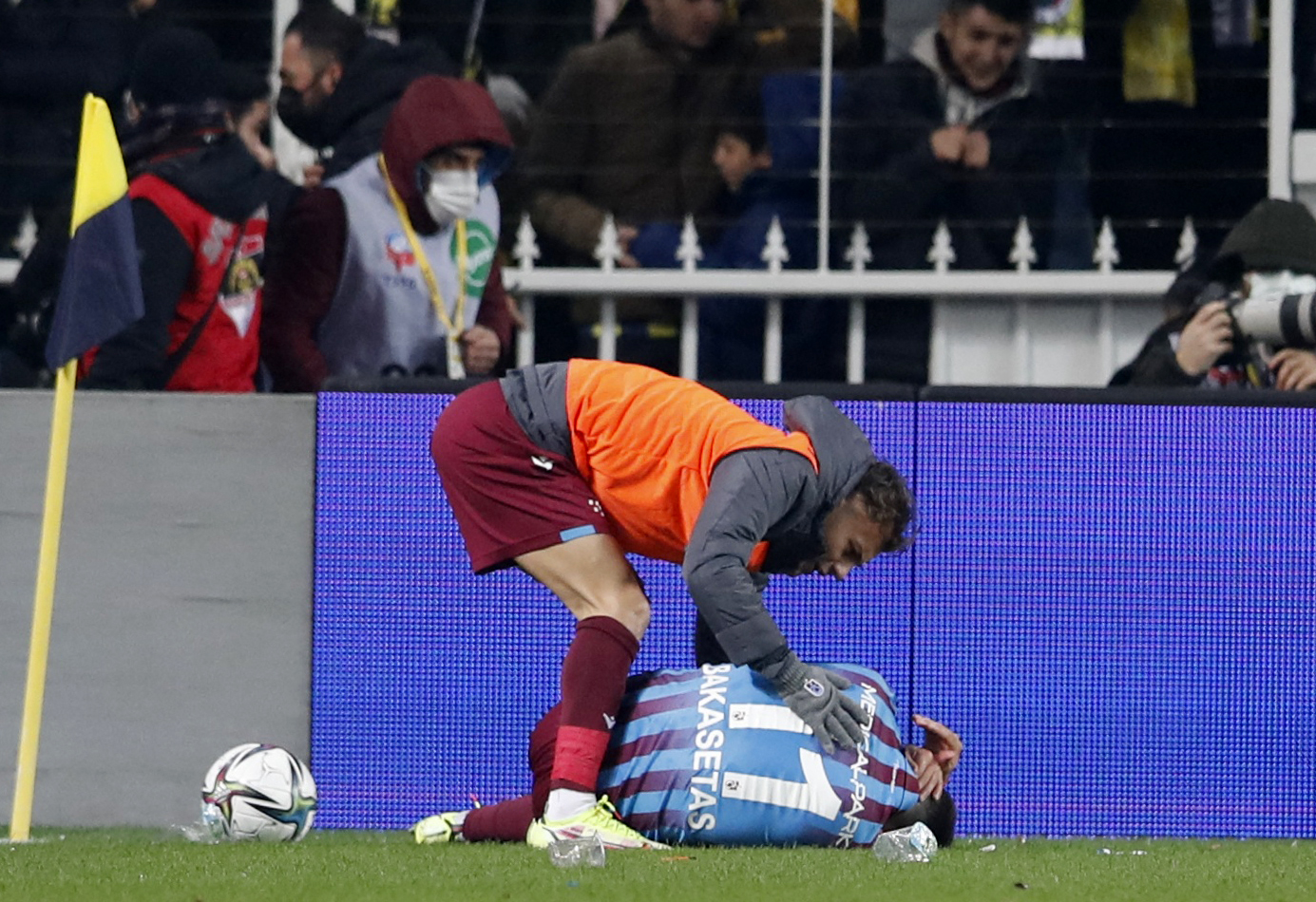 Soccer Football - Super Lig - Fenerbahce vs Trabzonspor - Sukru Saracoglu Stadium, Istanbul, Turkey - March 6, 2022 Trabzonspor's Anastasios Bakasetas receives medical attention after being hit by an object that was thrown by a fan REUTERS