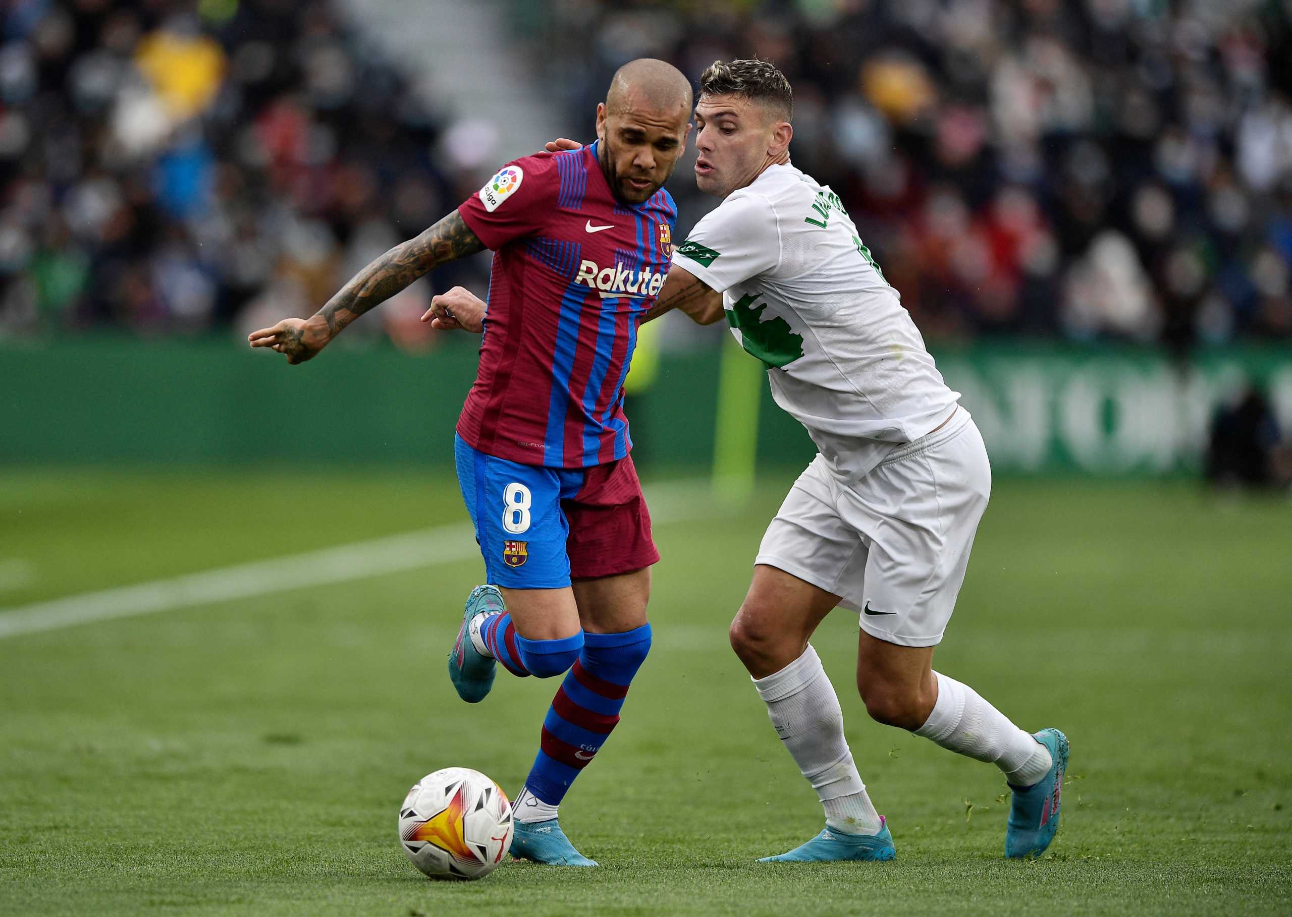 Soccer Football - LaLiga - Elche v Barcelona - Estadio Manuel Martinez Valero, Elche, Spain - March 6, 2022  FC Barcelona's Dani Alves in action with Elche's Lucas Boye REUTERS