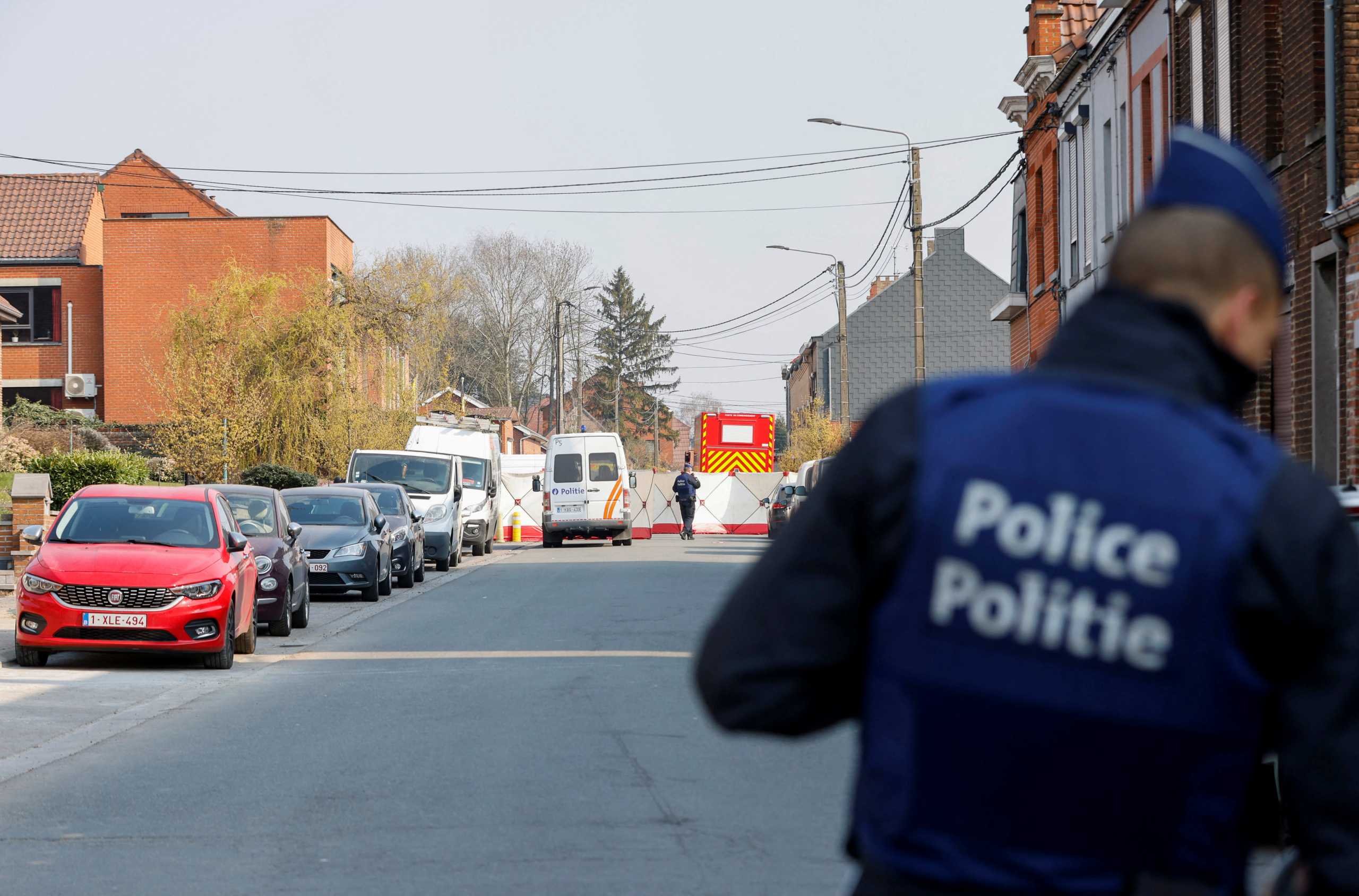 Police officers patrol at the site where a vehicle drove into a group of Belgian carnival performers who were preparing for a parade in the village of Strepy-Bracquegnies, Belgium March 20, 2022. REUTERS