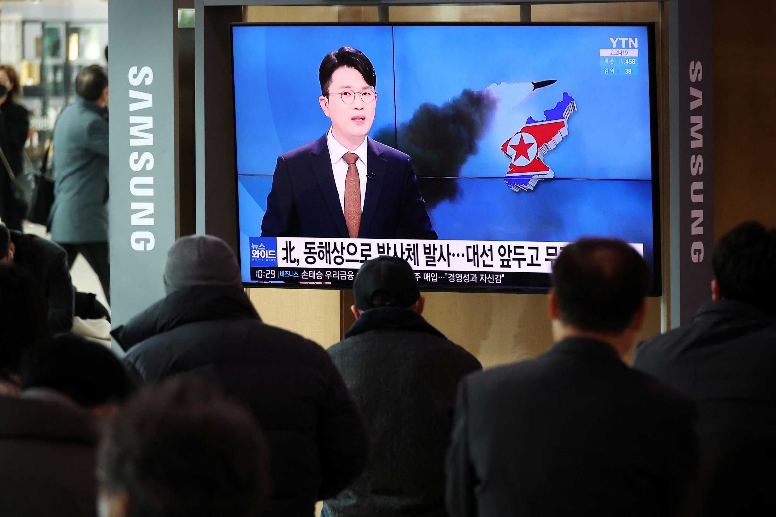 People watch a TV broadcasting a news report on North Korea's firing a ballistic missile off its east coast, in Seoul, South Korea, March 5, 2022.   REUTERS