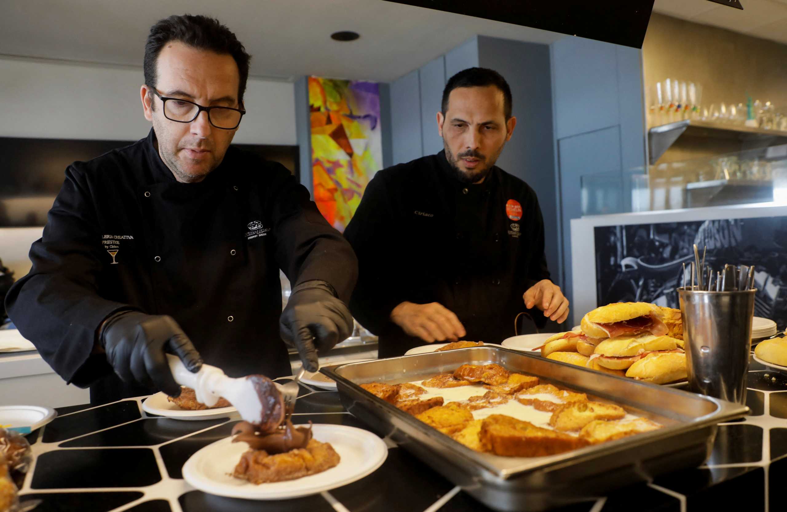 Spanish chef Ciriaco Vicente, 47, and his chef prepares sandwiches and sweets for Ukrainian refugees who come to eat at his restaurant on the beach in Valencia, Spain, March 28, 2022. Picture taken March 28, 2022. REUTERS