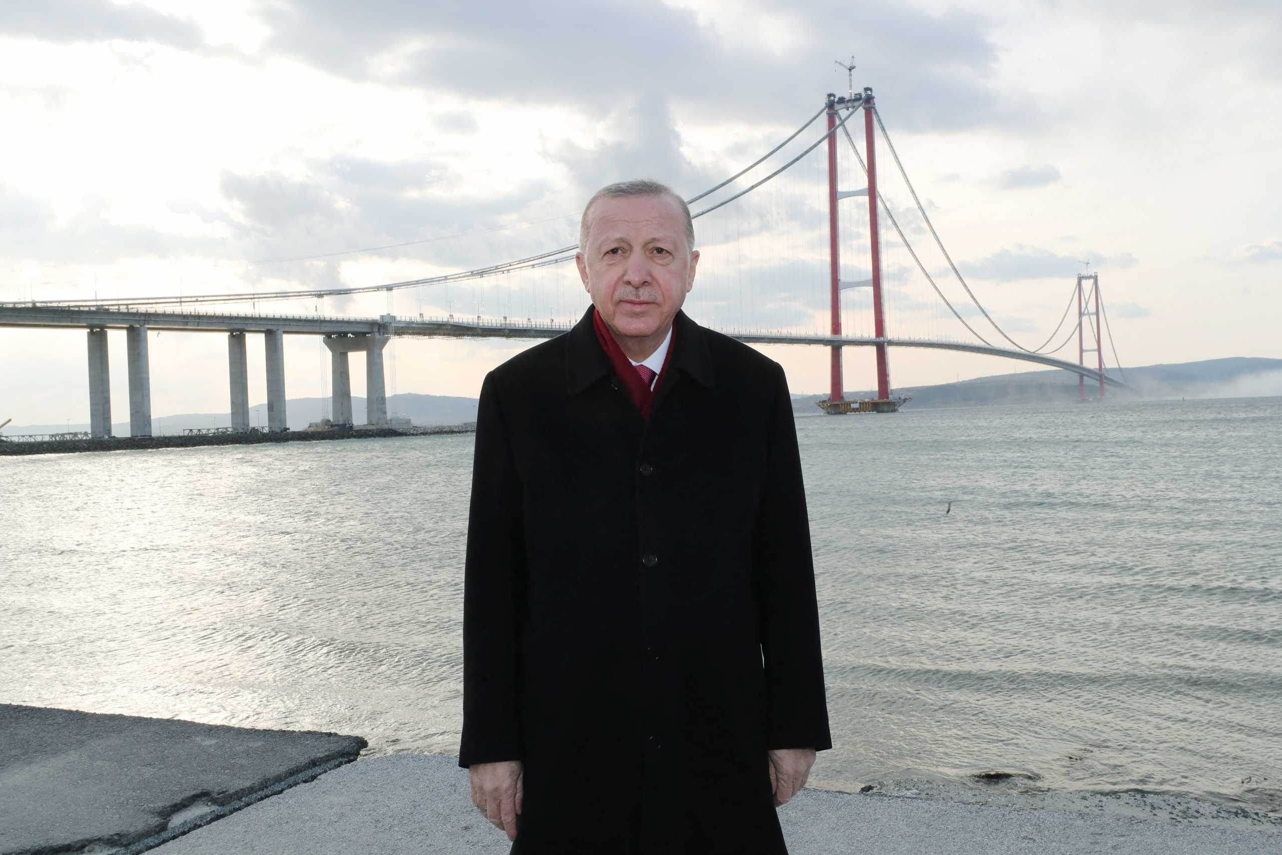 Turkish President Tayyip Erdogan poses for photographs with the 1915 Canakkale Bridge over the Dardanelles in the background, in Canakkale, Turkey March 18, 2022. Murat Cetinmuhurdar