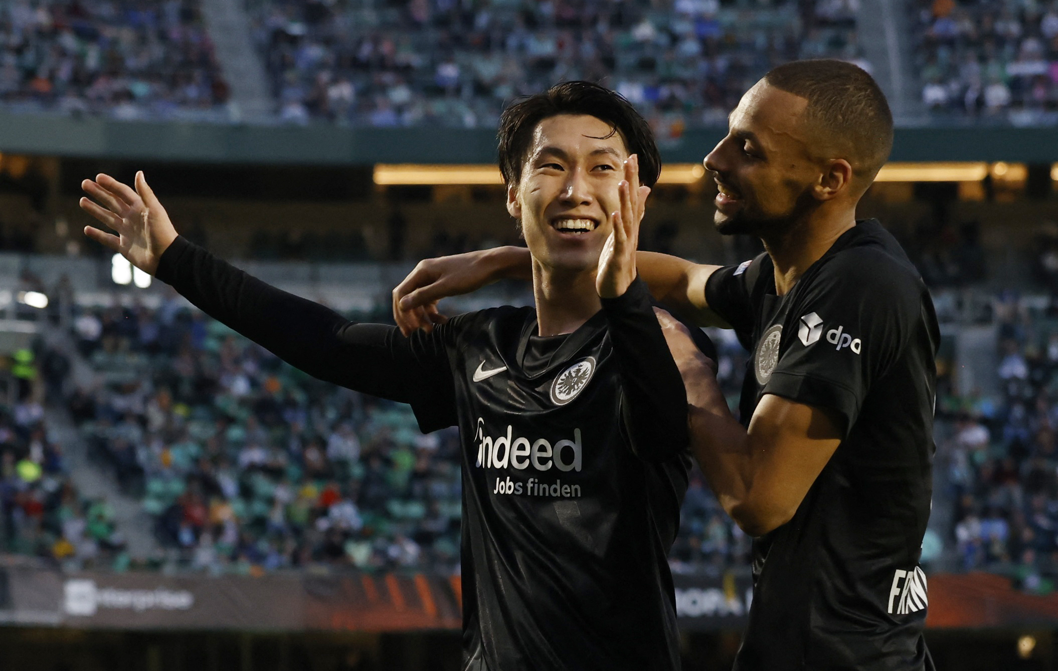 Soccer Football - Europa League - Round of 16 First Leg - Real Betis v Eintracht Frankfurt - Estadio Benito Villamarin, Seville, Spain - March 9, 2022 Eintracht Frankfurt's Daichi Kamada celebrates scoring their second goal with Djibril Sow REUTERS