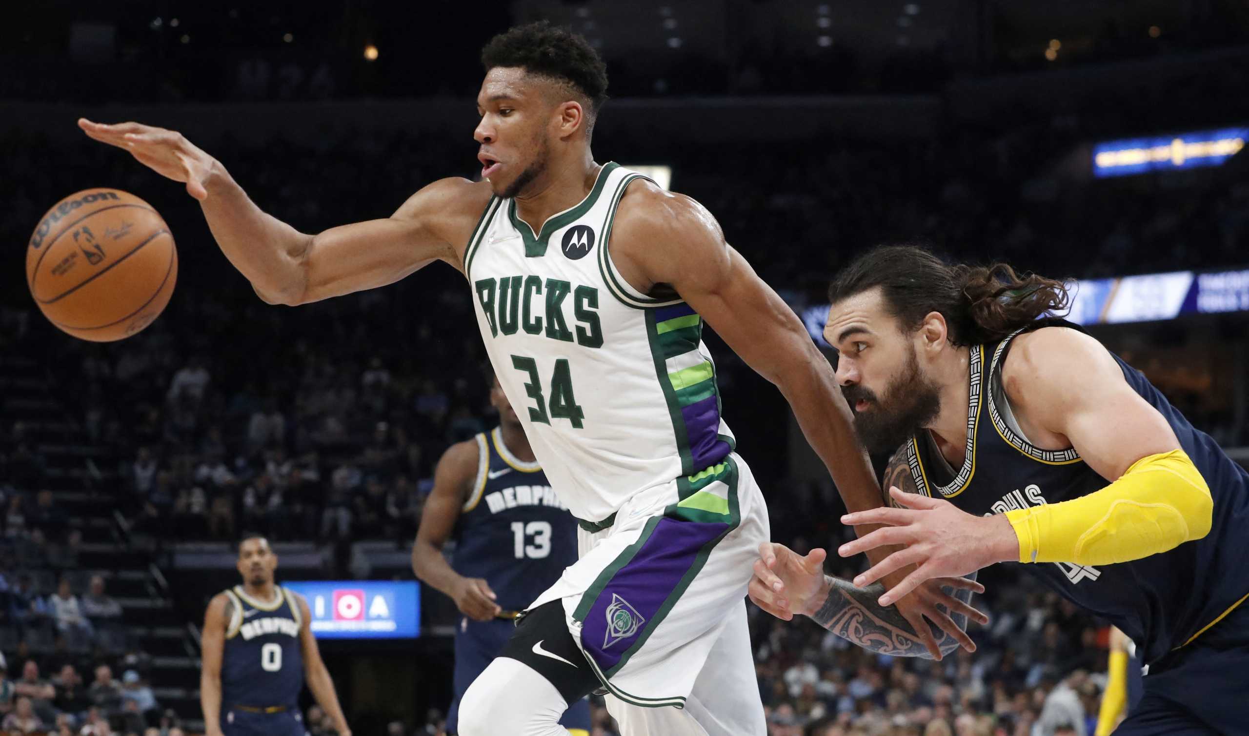 Mar 26, 2022; Memphis, Tennessee, USA; Milwaukee Bucks forward Giannis Antetokounmpo (34) and Memphis Grizzlies center Steven Adams (4) fight for control of the ball during the first half at FedExForum. Mandatory Credit: Christine Tannous-USA TODAY Sports