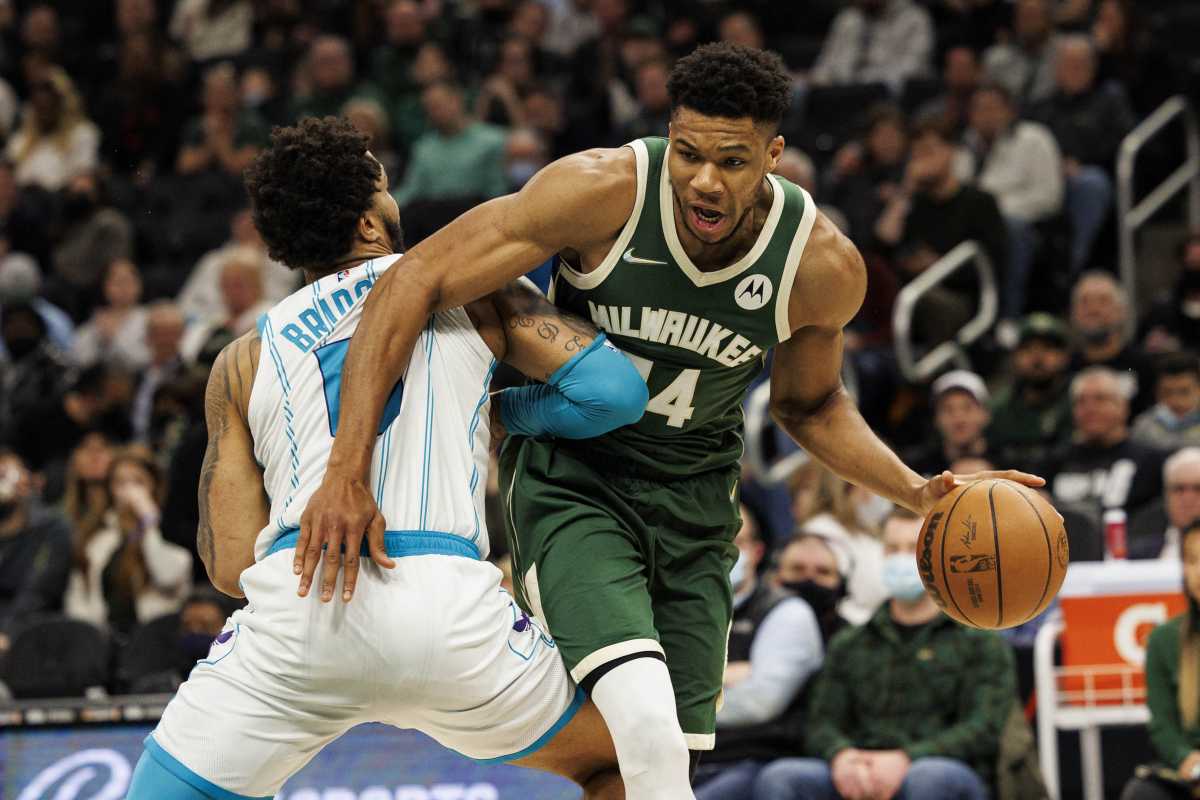 Feb 28, 2022; Milwaukee, Wisconsin, USA;  Milwaukee Bucks forward Giannis Antetokounmpo (34) drives for the basket around Charlotte Hornets forward Miles Bridges (0) during the second quarter at Fiserv Forum. Mandatory Credit: Jeff Hanisch-USA TODAY Sports
