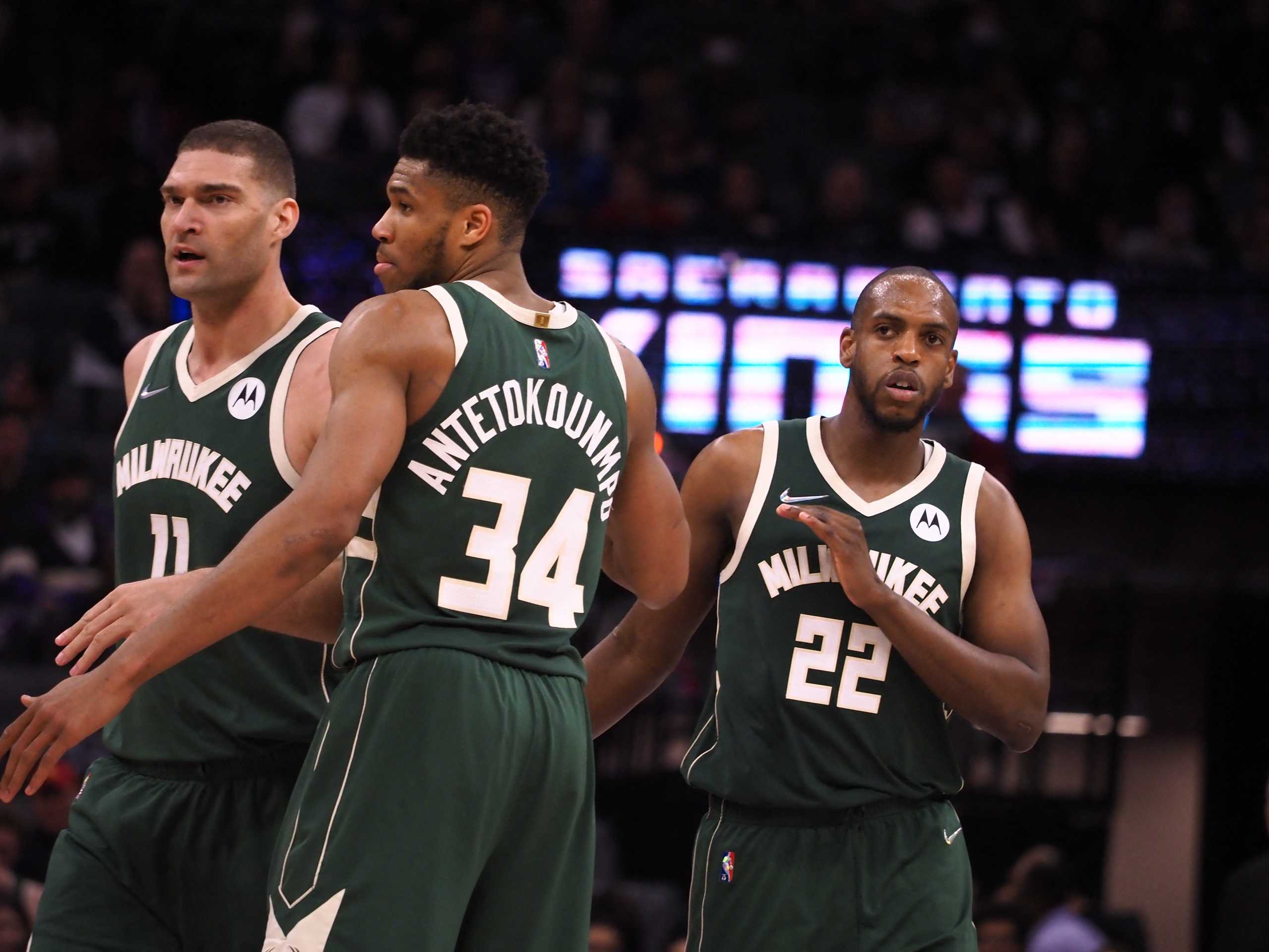 Mar 16, 2022; Sacramento, California, USA; Milwaukee Bucks forward Khris Middleton (22) celebrates with center Brook Lopez (11) and forward Giannis Antetokounmpo (34) after a play against the Sacramento Kings during the fourth quarter at Golden 1 Center. Mandatory Credit: Kelley L Cox-USA TODAY Sports