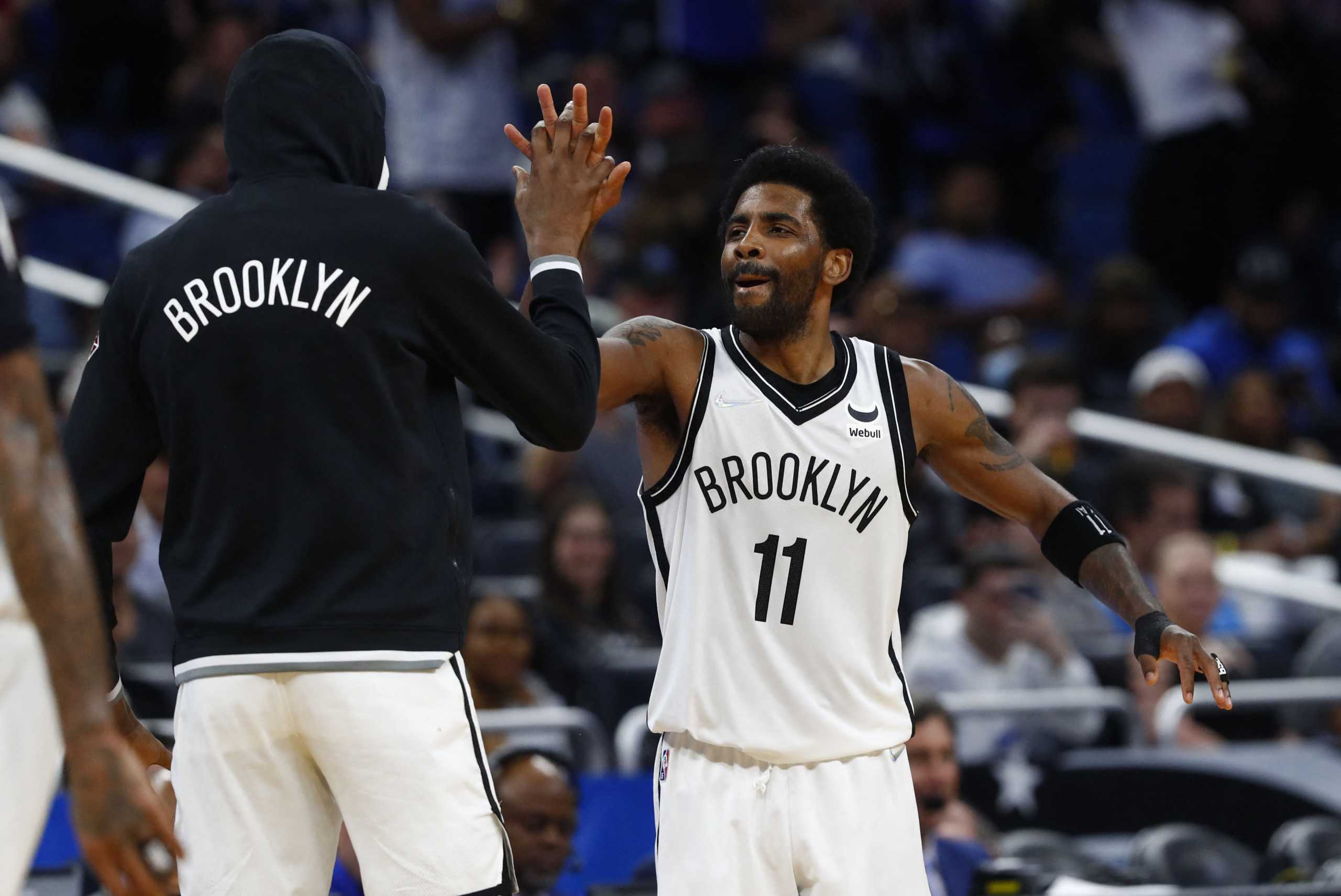 Mar 15, 2022; Orlando, Florida, USA; Brooklyn Nets guard Kyrie Irving (11) celebrates during the second half with forward Kevin Durant (7) after scoring a career high 60 points against the Orlando Magic at Amway Center. Mandatory Credit: Kim Klement-USA TODAY Sports