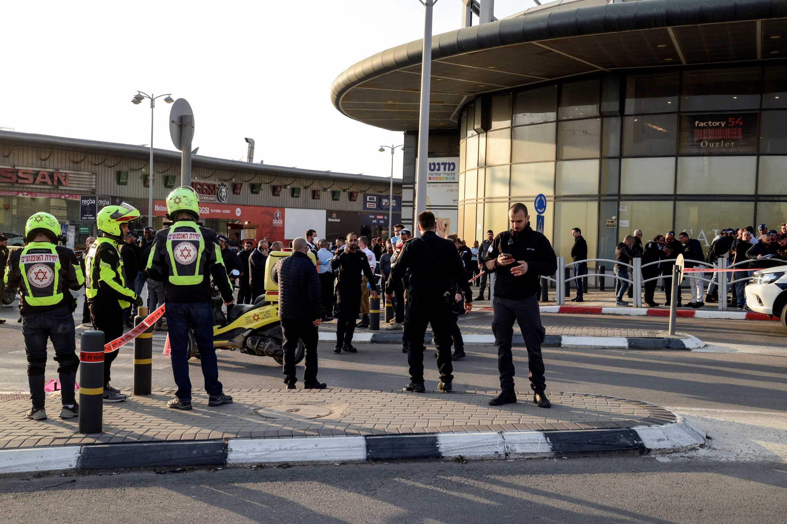 Israeli security and rescue forces secure the scene of an attack in which people were killed near a shopping centre in Beersheba, Israel, March 22, 2022. REUTERS