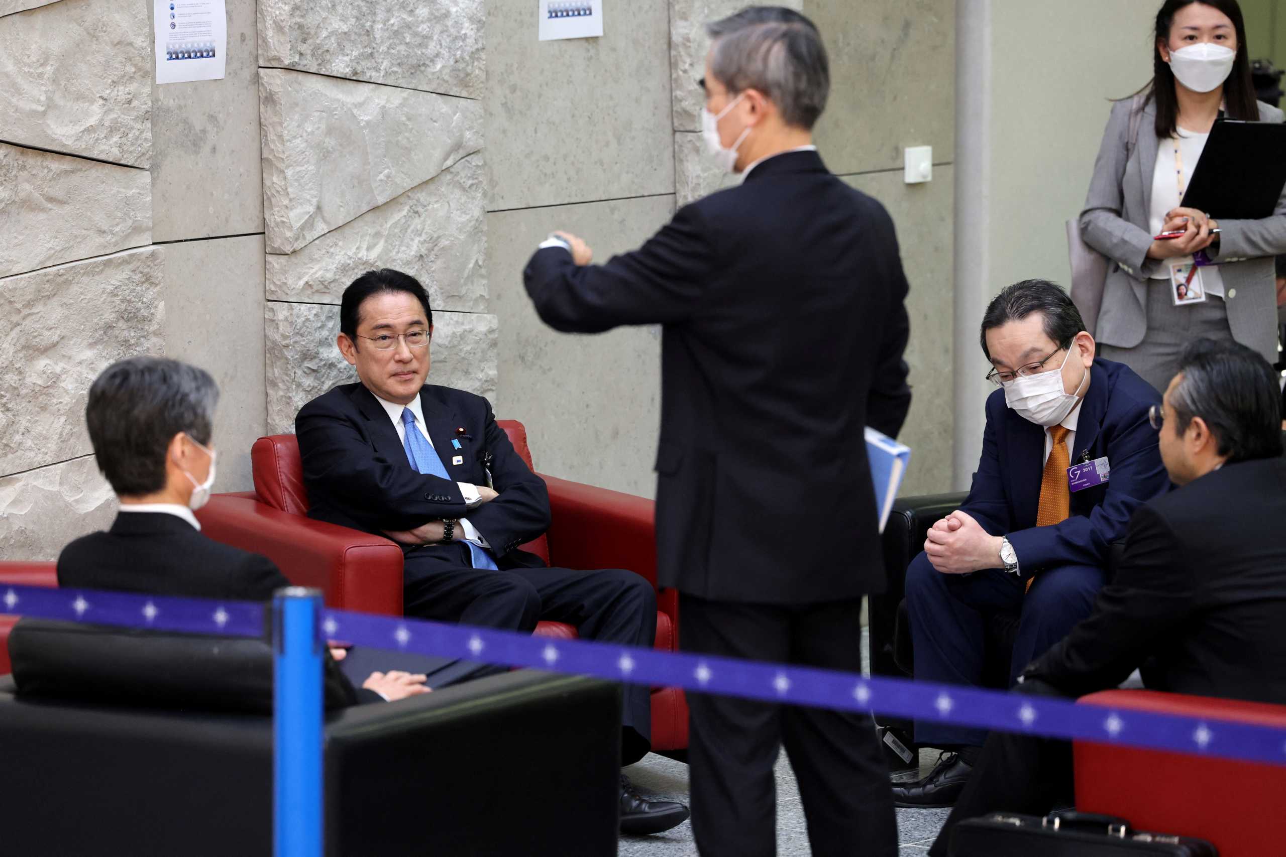 Japan's Prime Minister Fumio Kishida waits with officials ahead of the start of a G7 summit in Brussels, Belgium, March 24, 2022. Thomas Coex